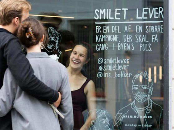 Iris draws portraits on window