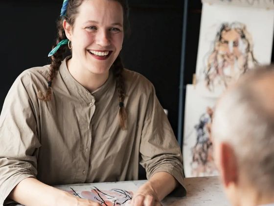 Iris drawing a guests at an event