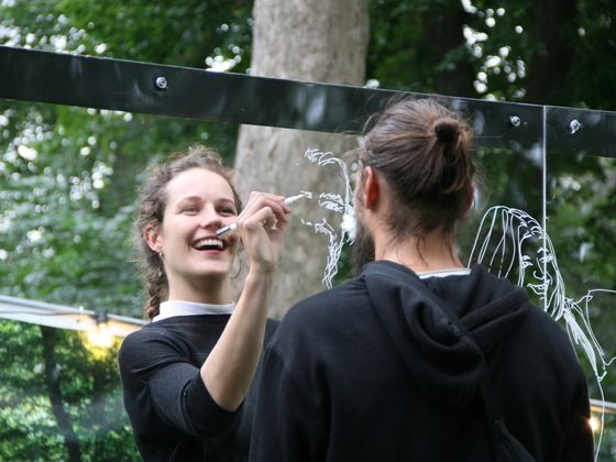 iris drawing a person on a window
