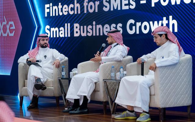 Three panelists in traditional Saudi dress sit on stage at LEAP 2026 in front of a screen reading "Fintech for SMEs - Powering Small Business Growth," with Eddekhar's Abdulkareem Alkhiary speaking into a microphone.