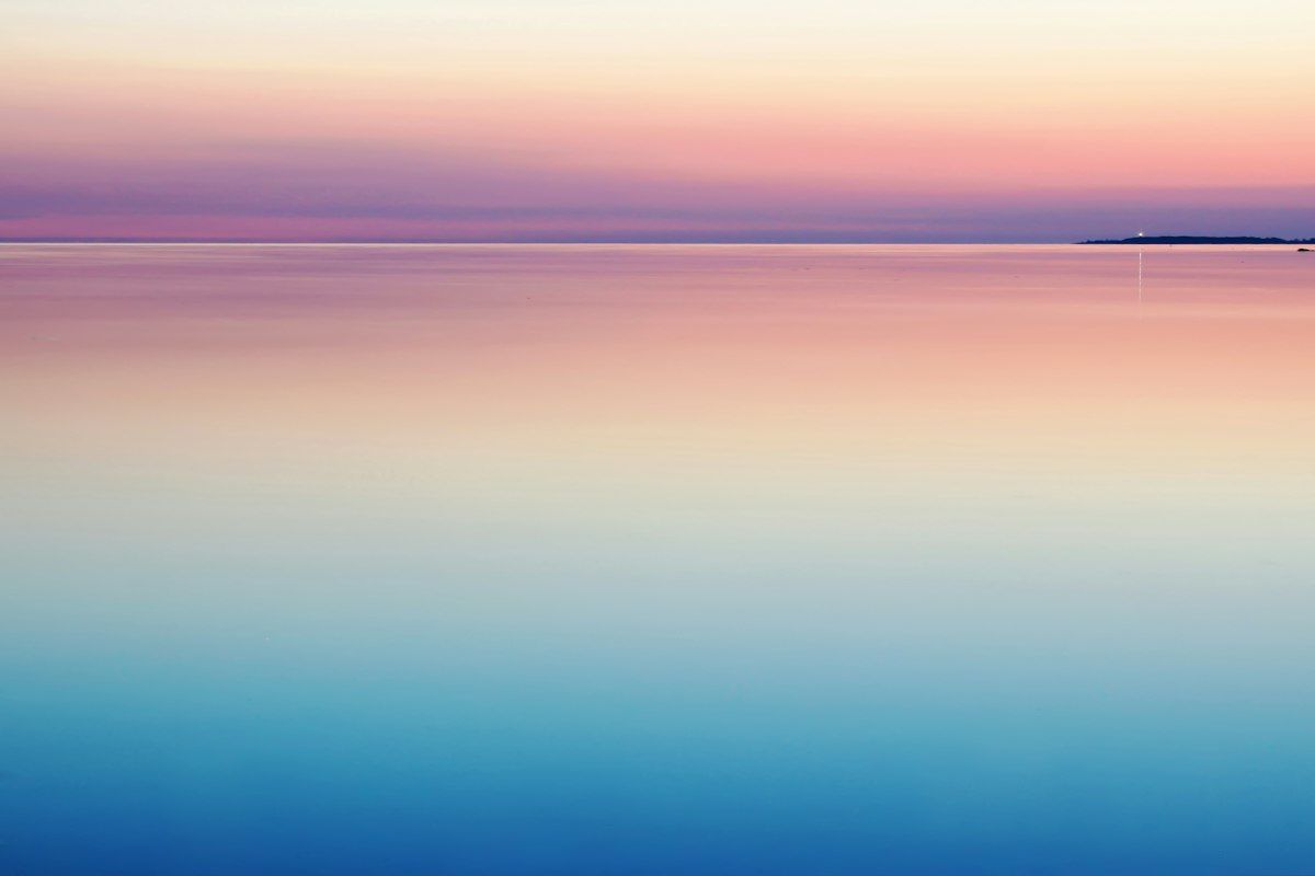 Calm pink and blue sea at dusk