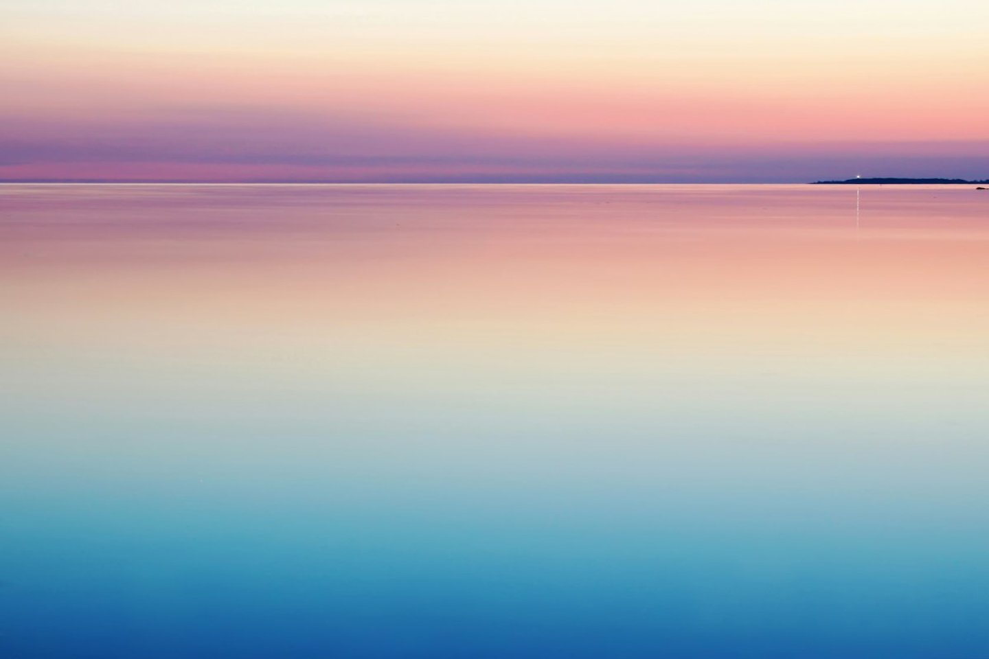 Calm pink and blue sea at dusk