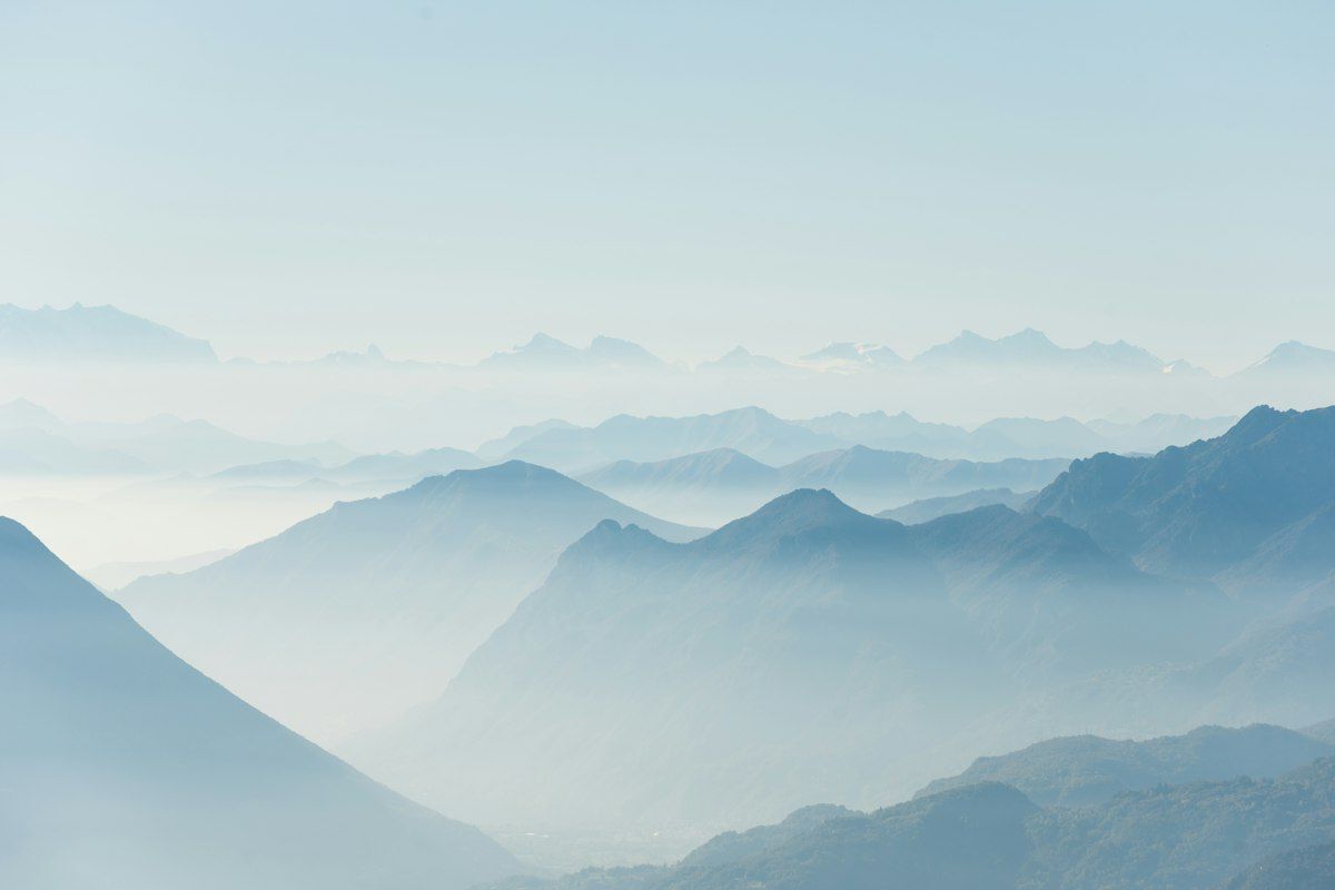 Misty mountain ridges in soft blue haze