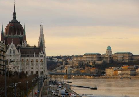 The Hungarian Parliament and the Danube in Budapest at golden hour, with the Chain Bridge and Buda Castle beyond