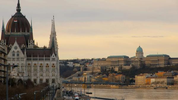 The Hungarian Parliament and the Danube in Budapest at golden hour, with the Chain Bridge and Buda Castle beyond