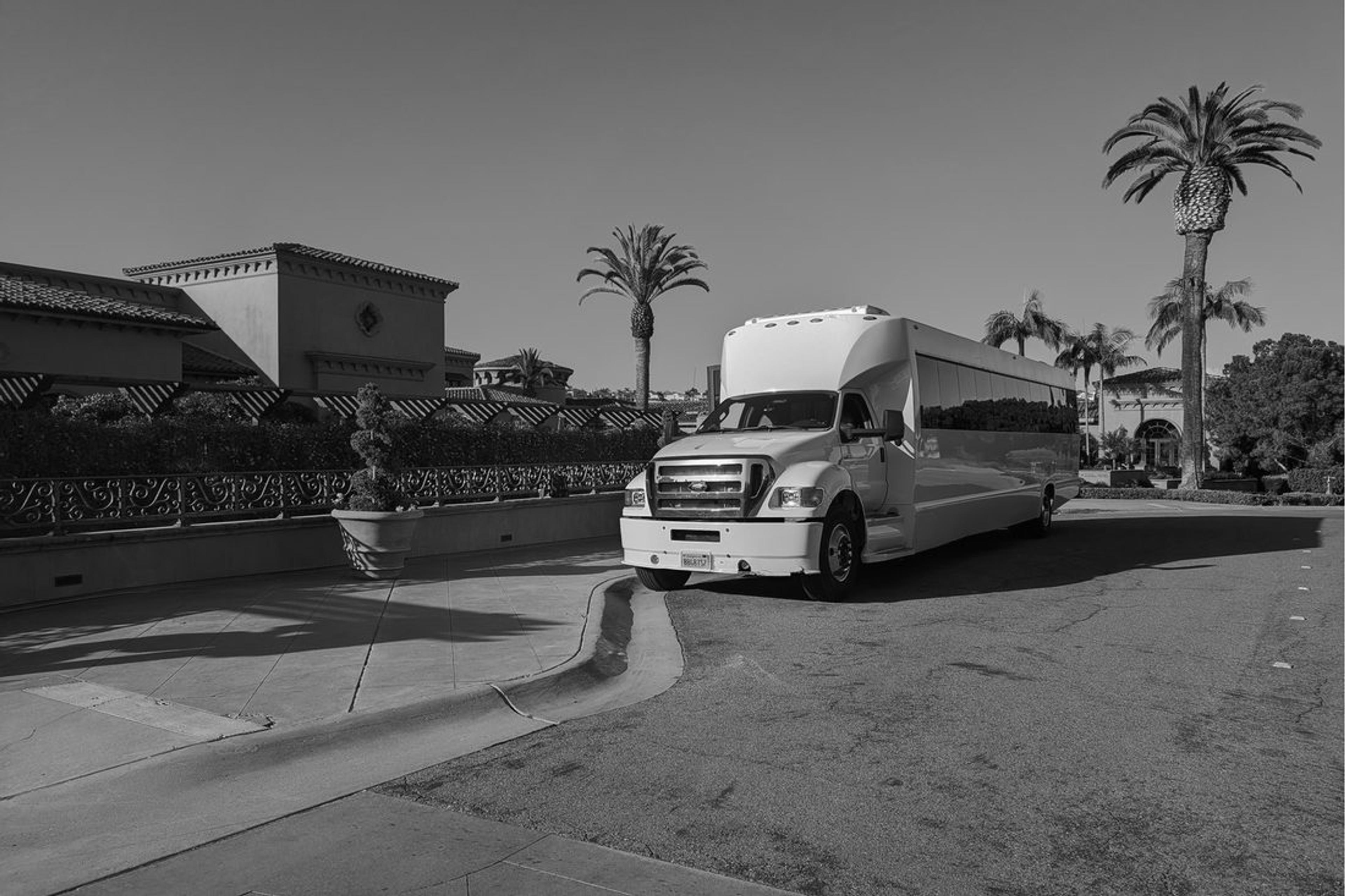 A coach waiting on the hotel forecourt before departure.