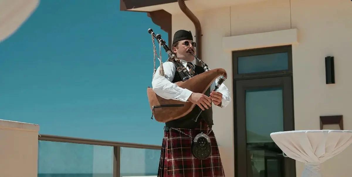 A piper performs during the closing terrace reception at Experience Camp Pendleton