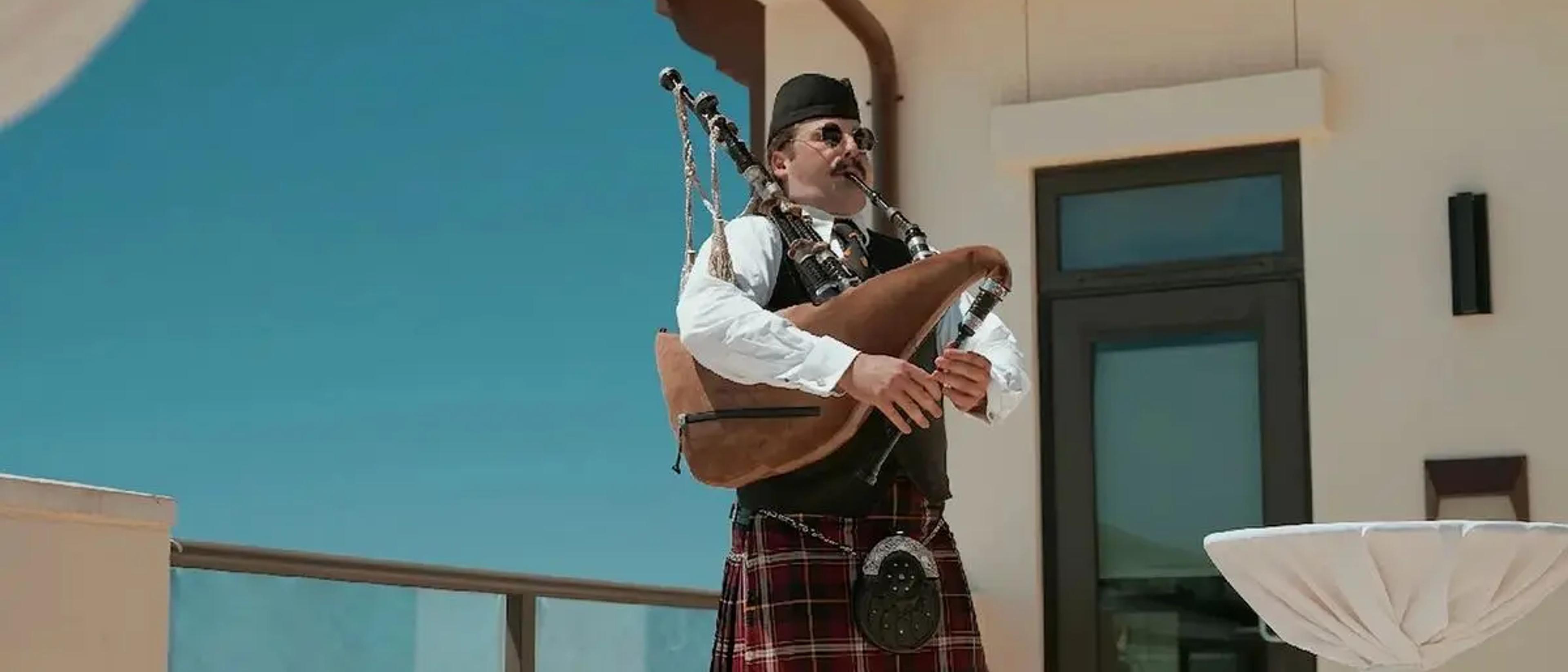 A piper performs during the closing terrace reception at Experience Camp Pendleton