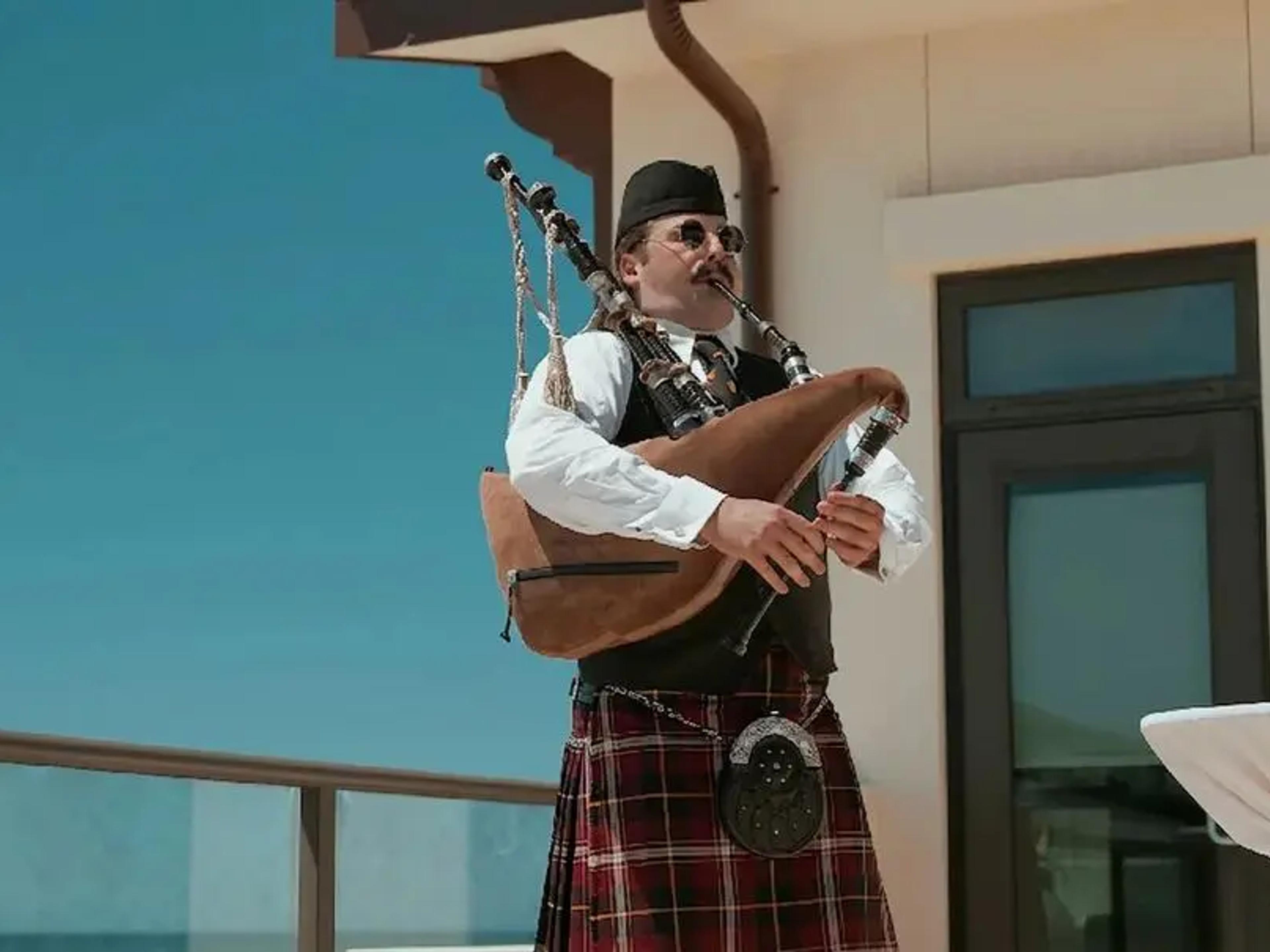 A piper performs during the closing terrace reception at Experience Camp Pendleton