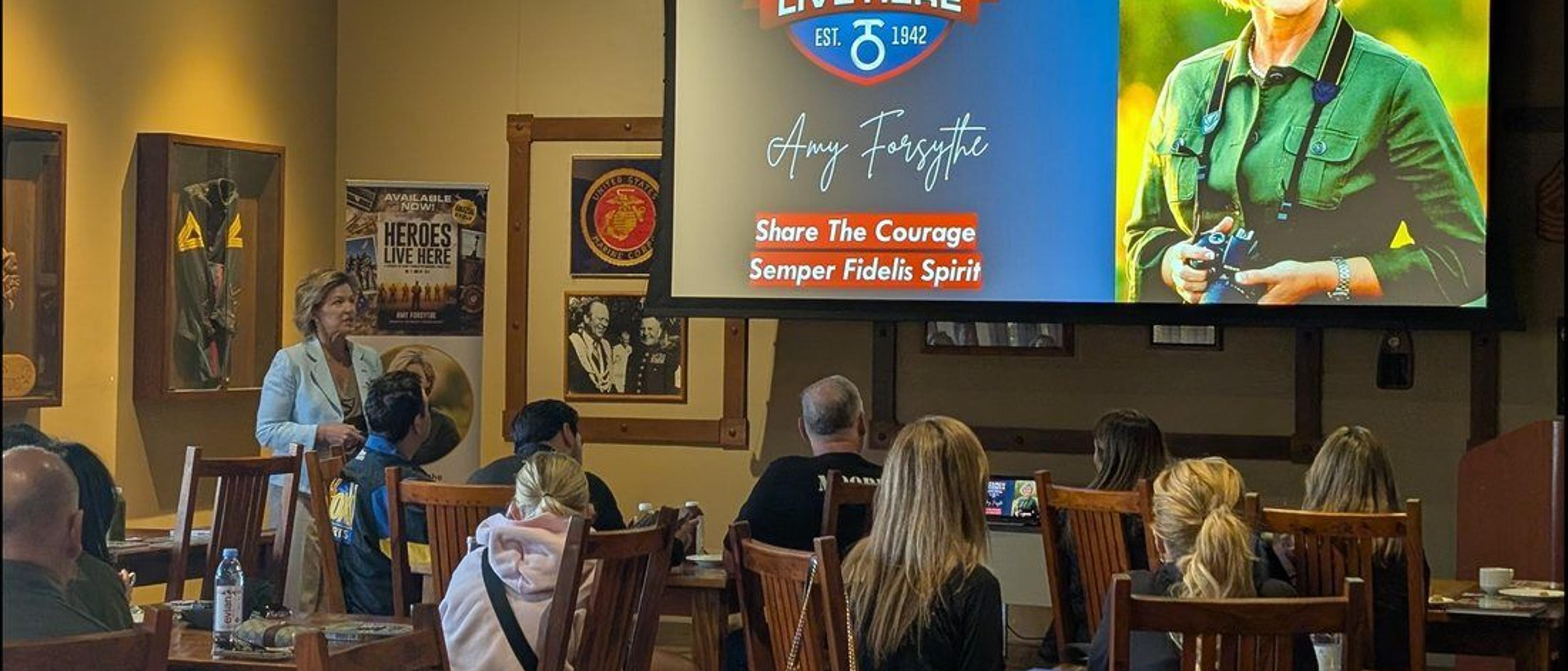 Amy Forsythe speaking to guests seated together at Camp Pendleton