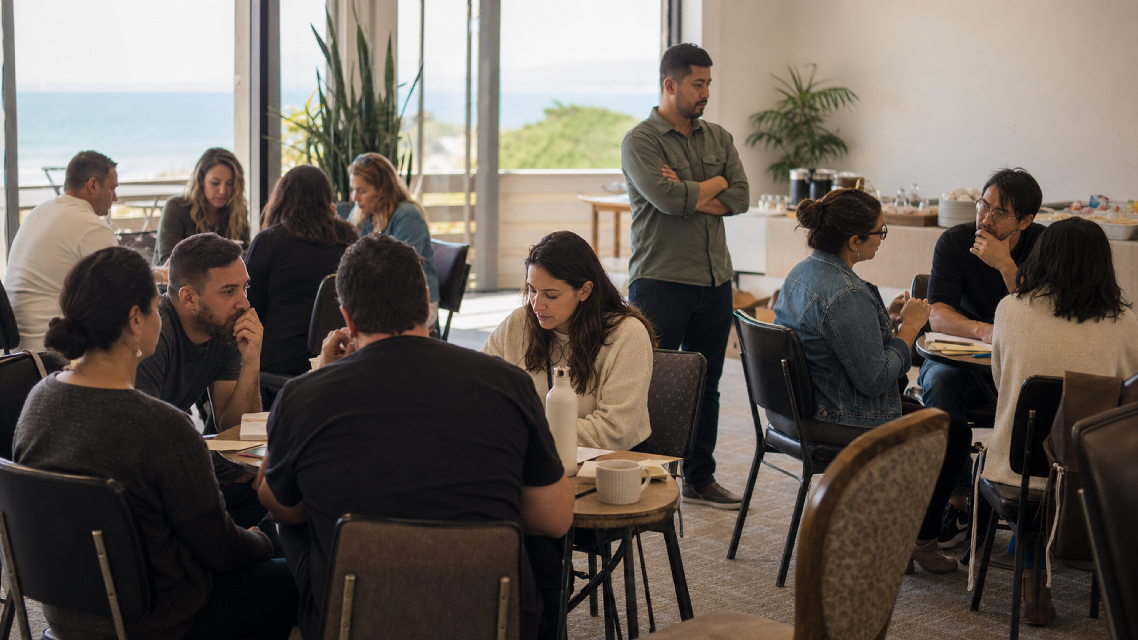 Coworkers collaborate in small groups during a one-day company retreat workshop