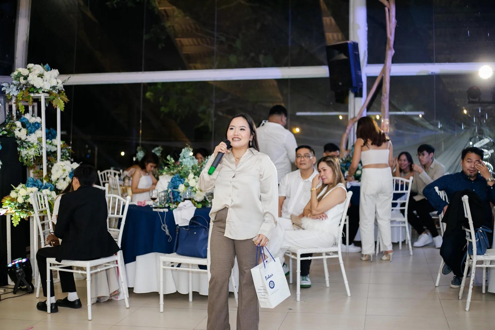 A speaker addressing guests at a corporate event in the Philippines