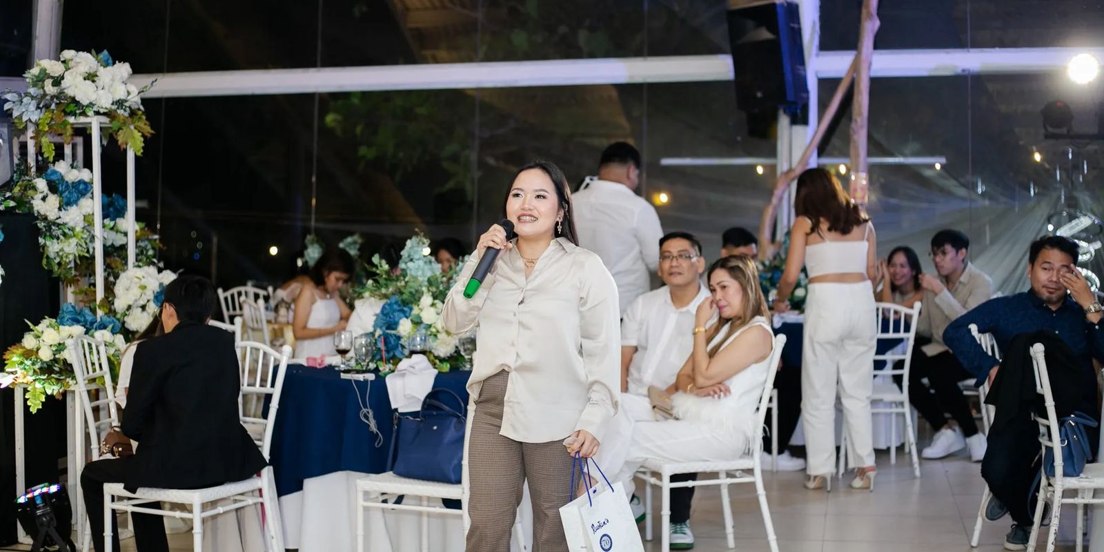 An emcee speaking to guests at a reception in the Philippines