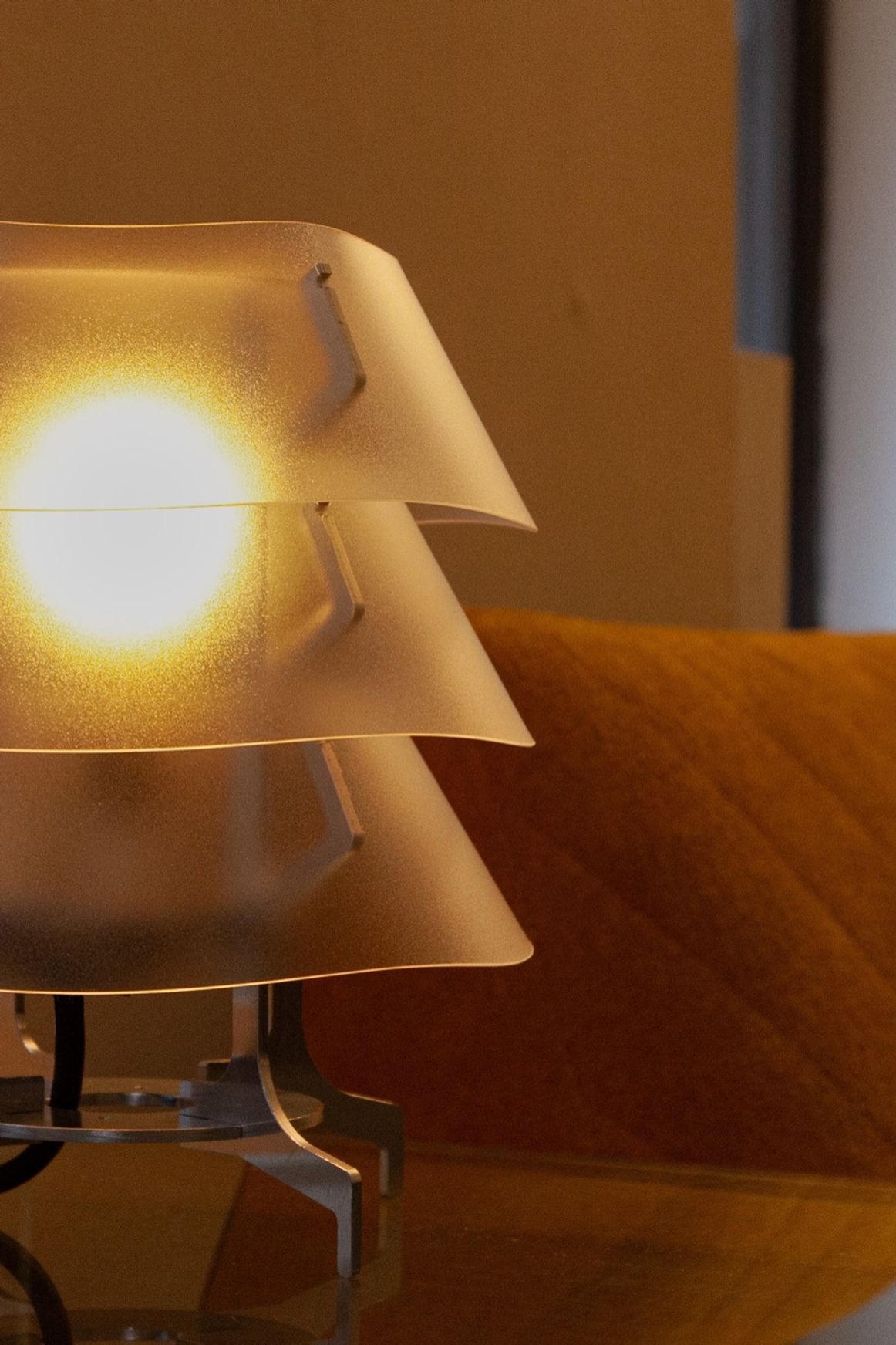 Aluminum and polycarbonate lamp in living room.