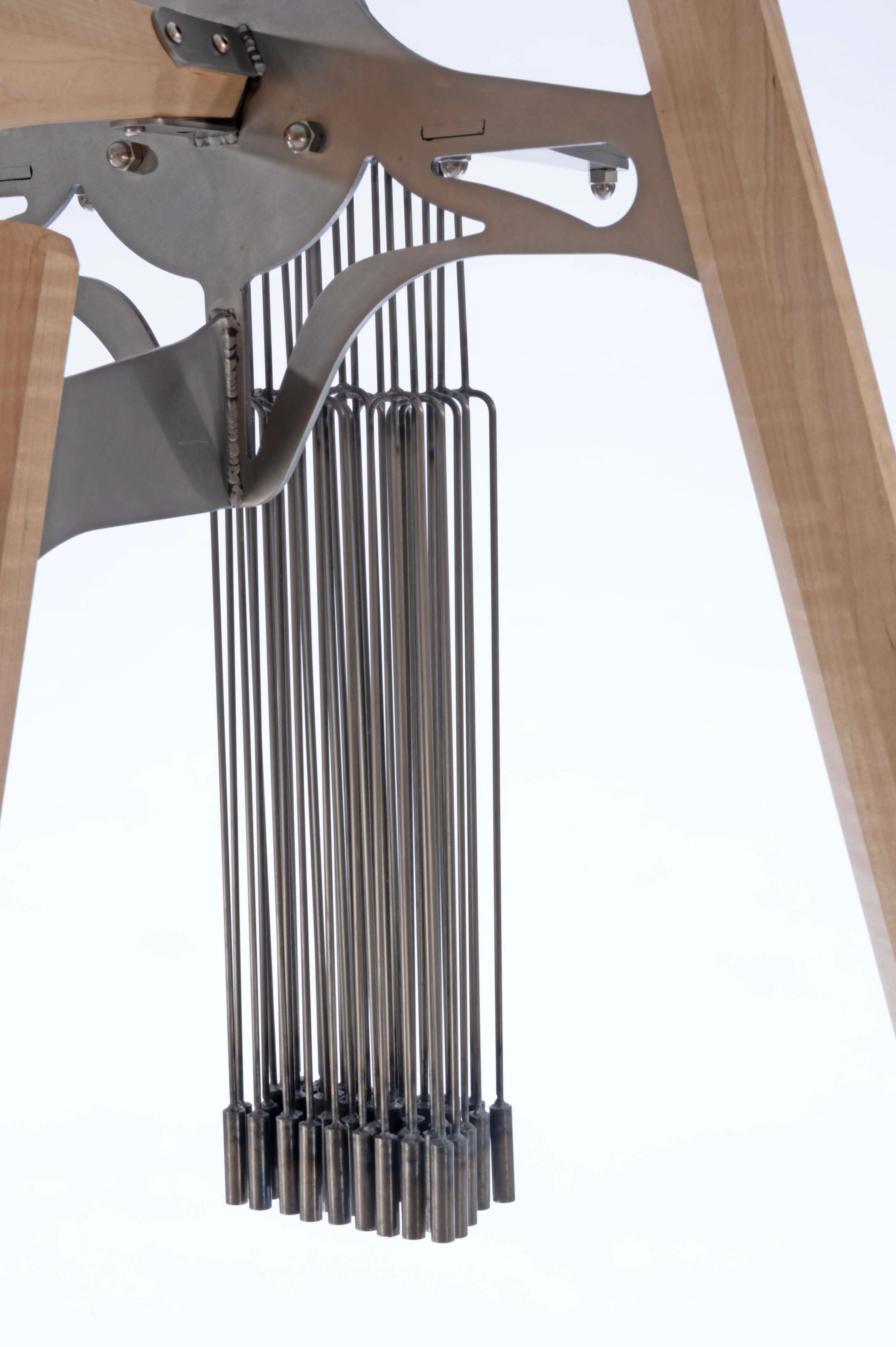 Steel and maple horn sculpture with chimes. 