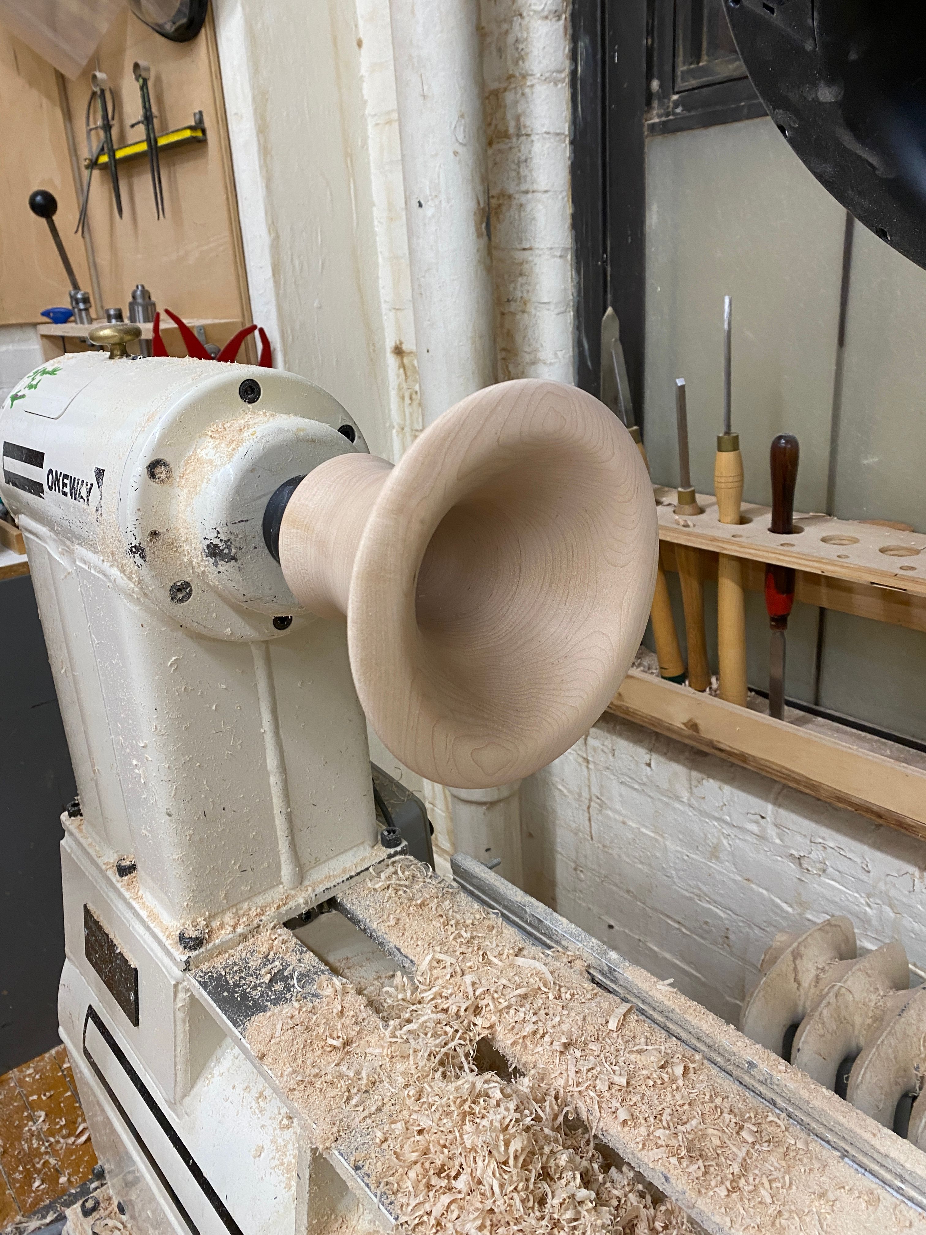 Maple horn on lathe. 