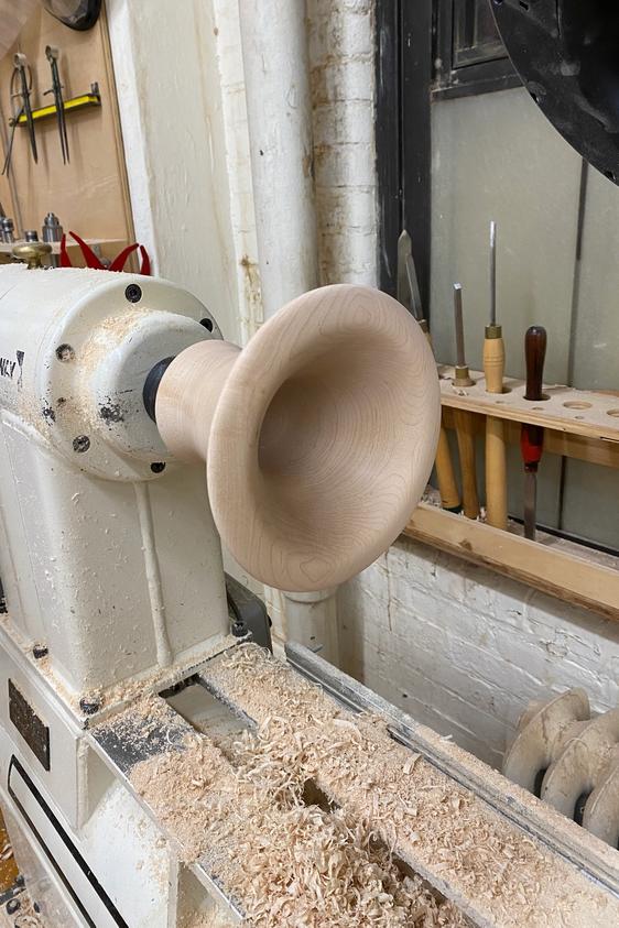 Maple horn on lathe.