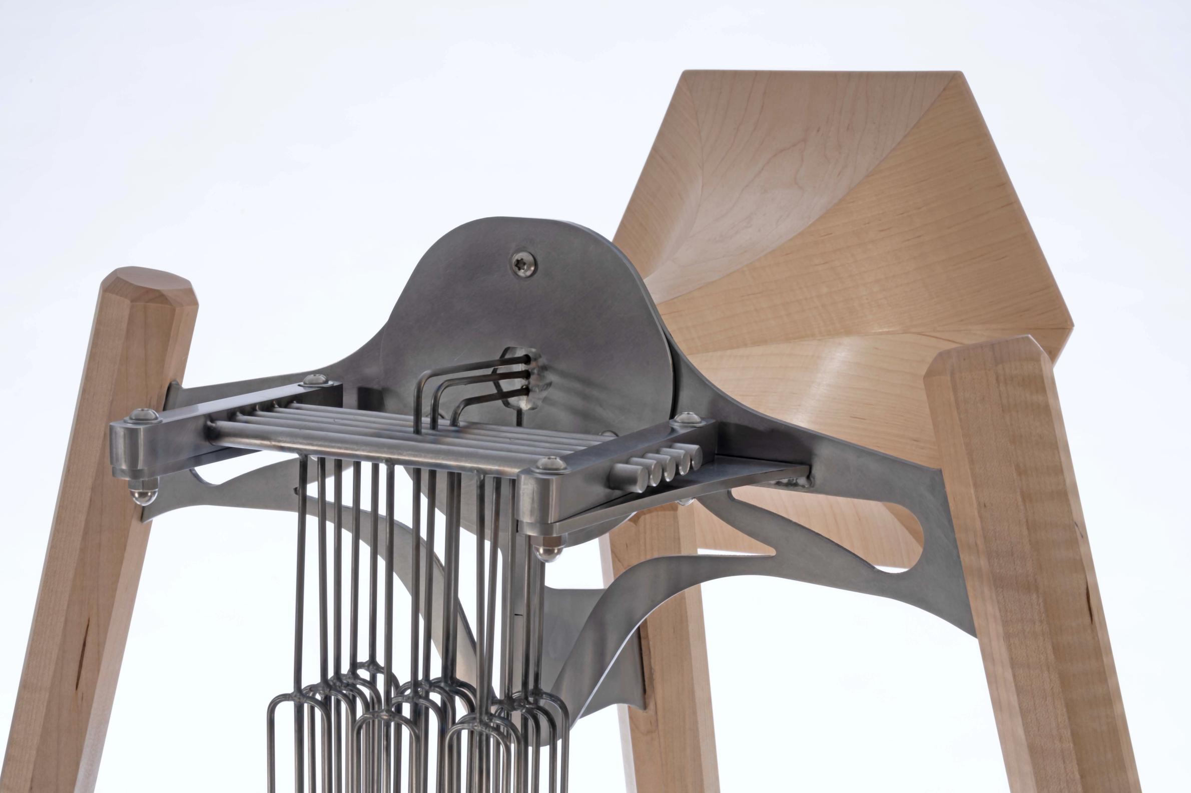 Steel and maple horn sculpture with chimes. 