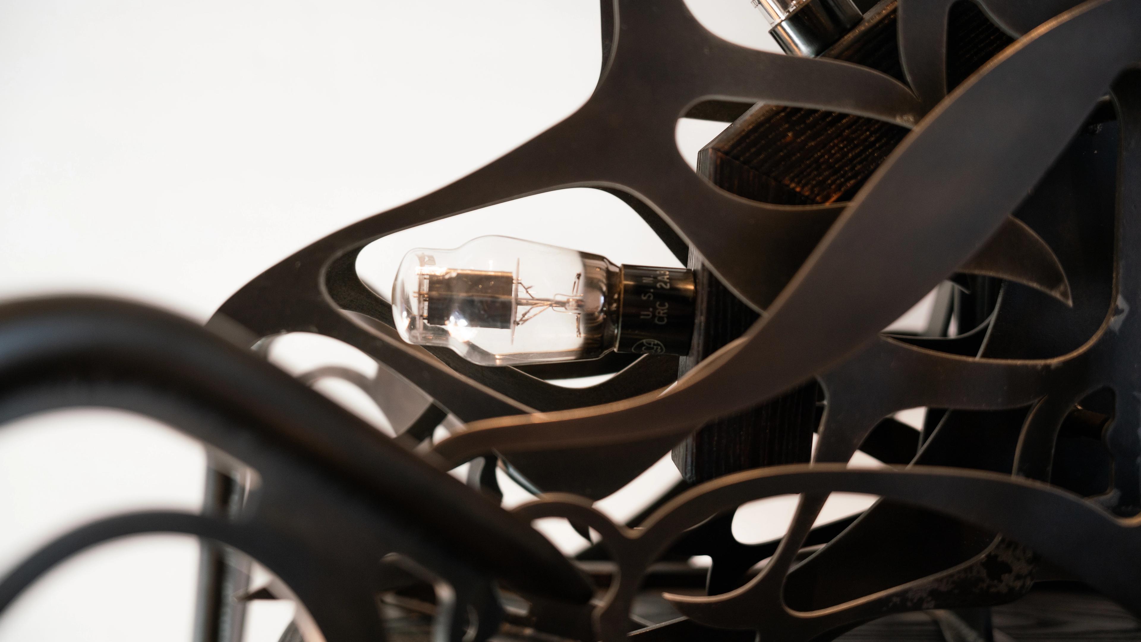 Ornamental blackened steel amplifier with tubes.
