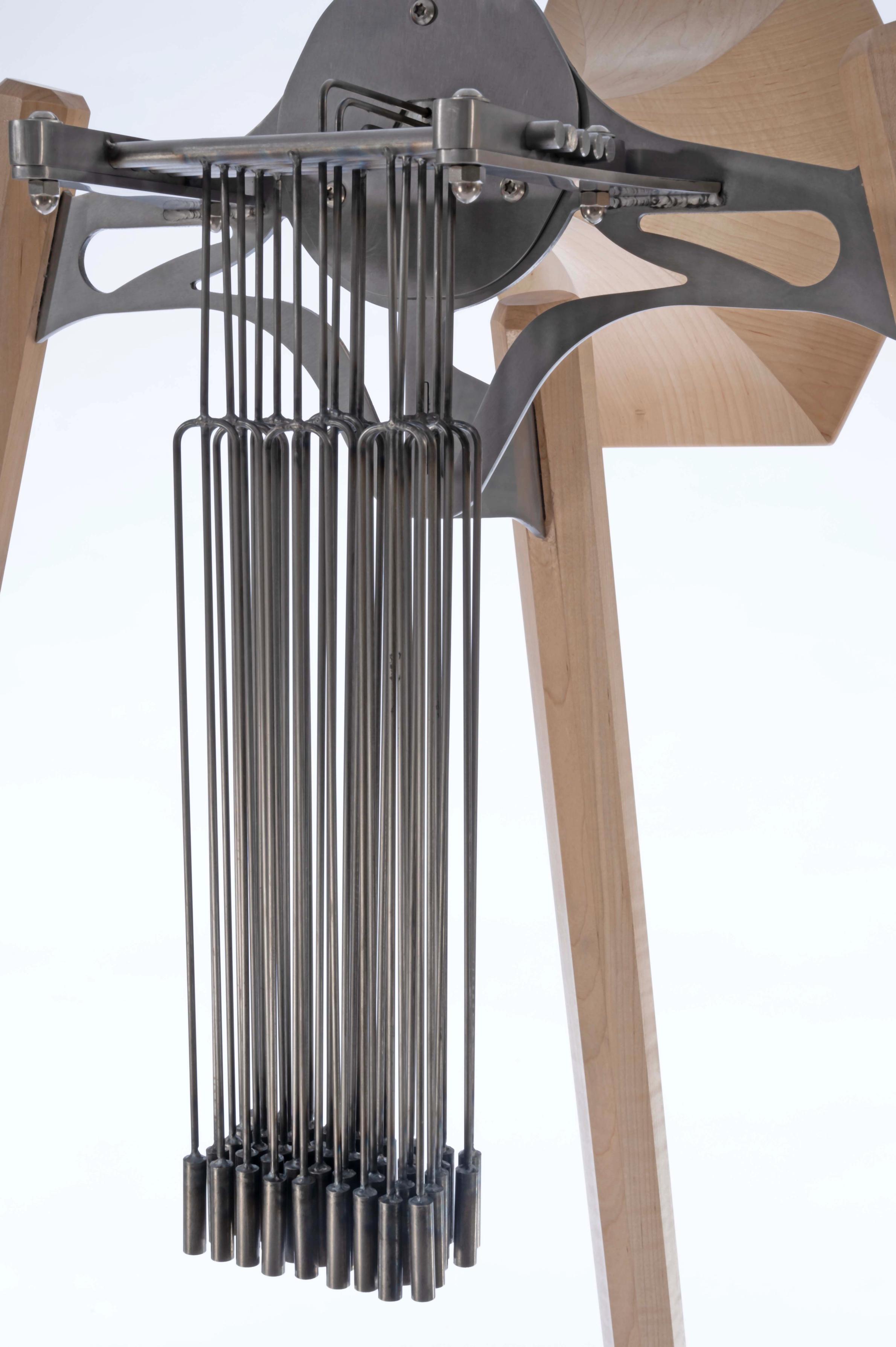Steel and maple horn sculpture with chimes. 