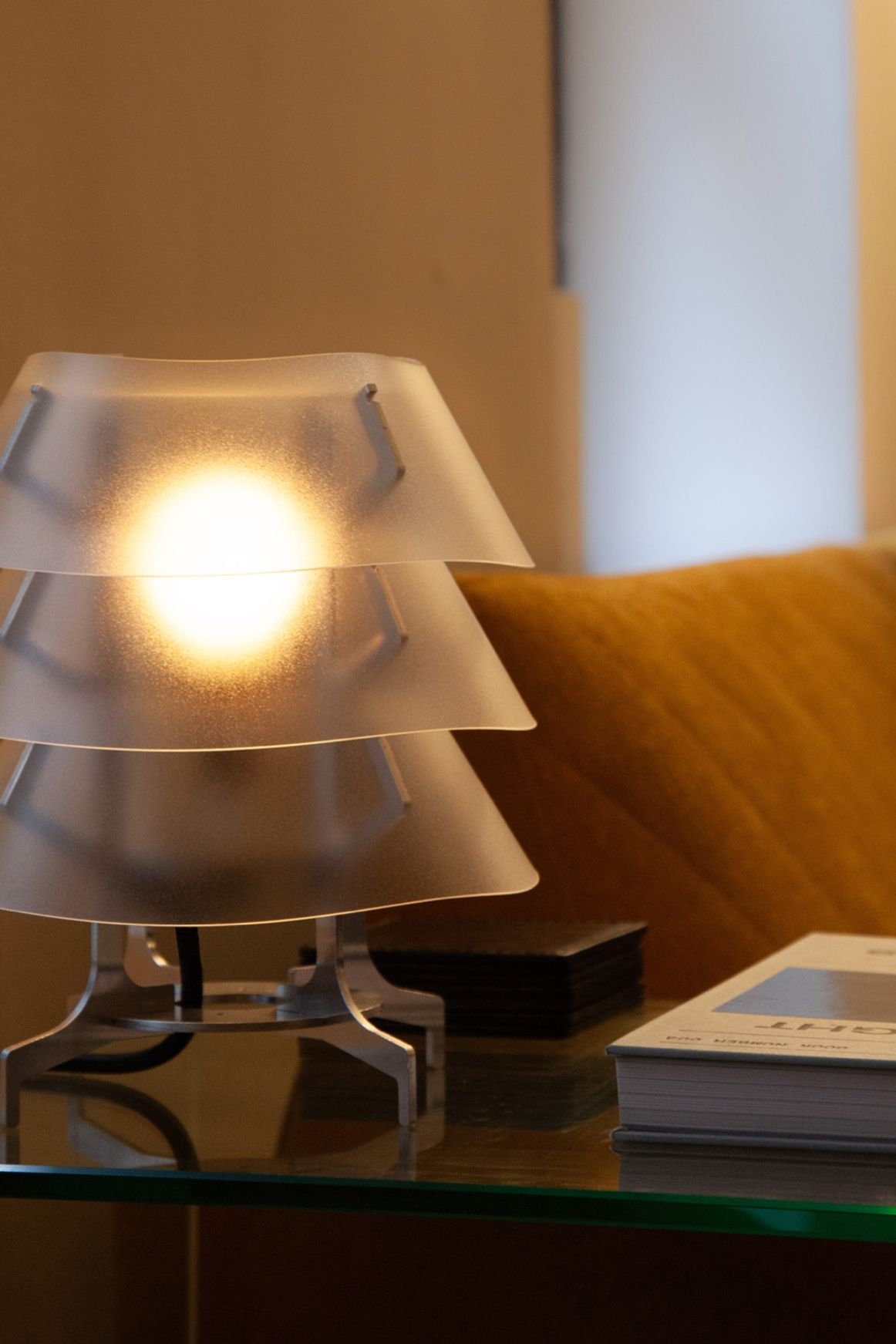 Aluminum and polycarbonate lamp in living room.