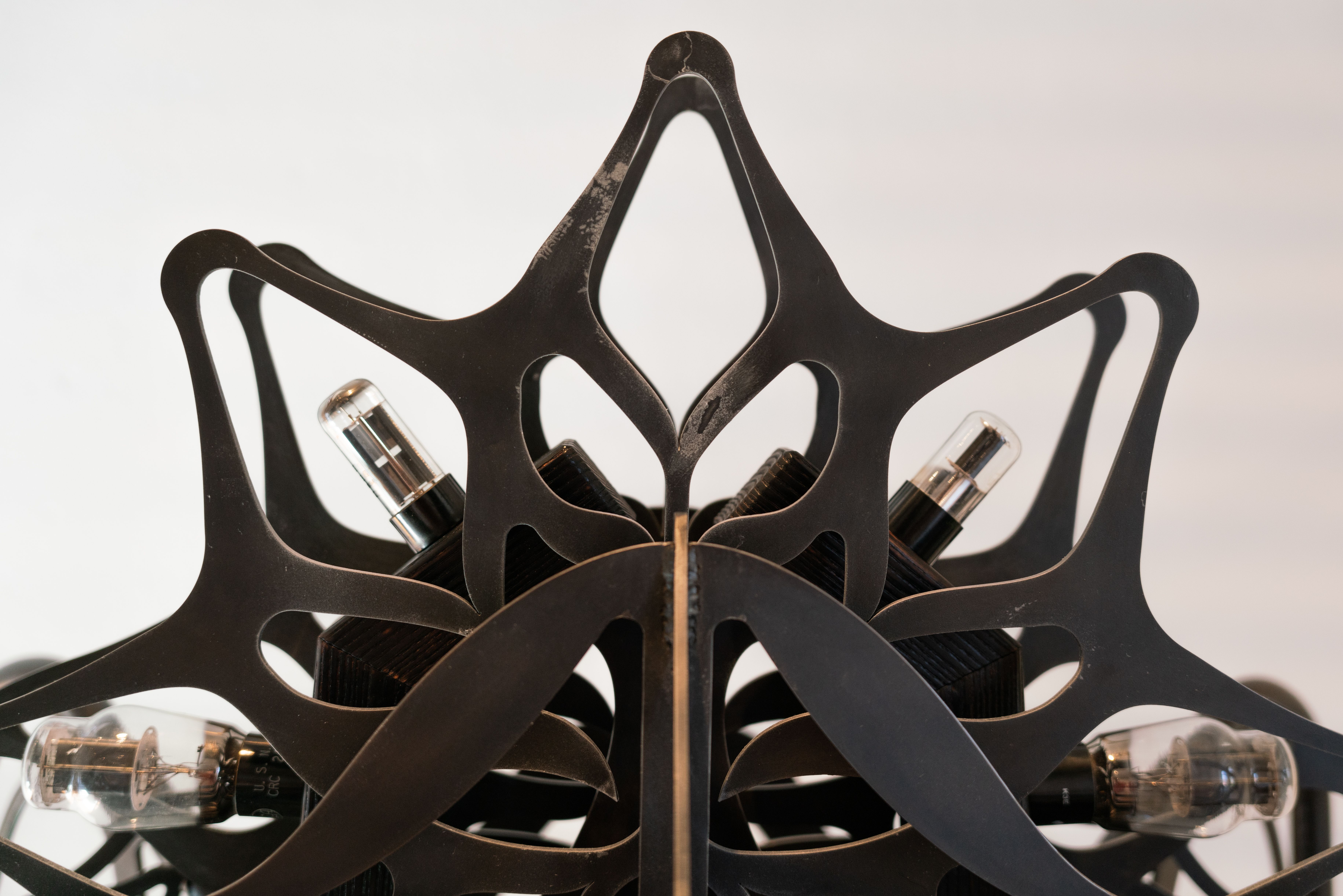 Ornamental blackened steel amplifier with tubes.