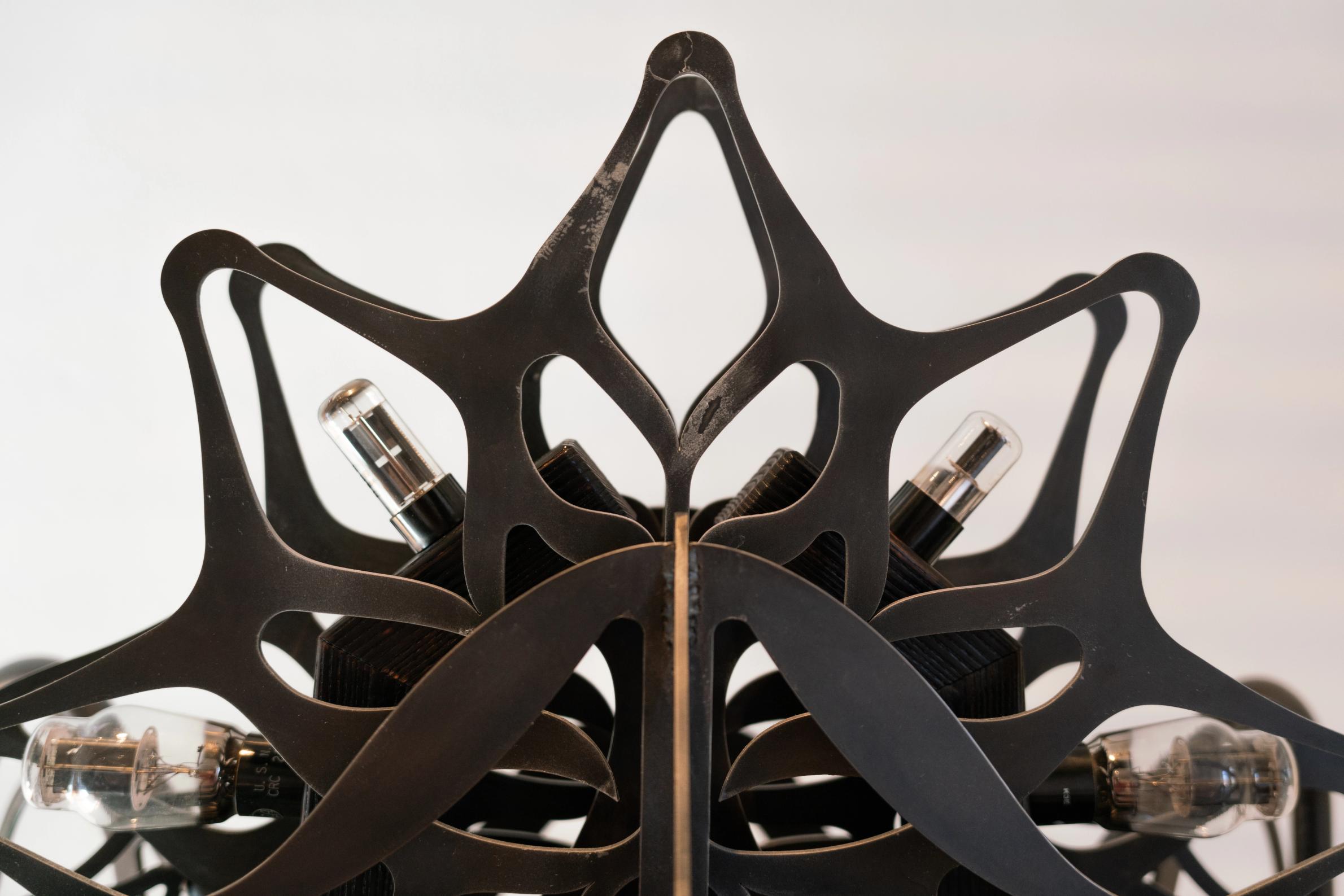 Ornamental blackened steel amplifier with tubes.