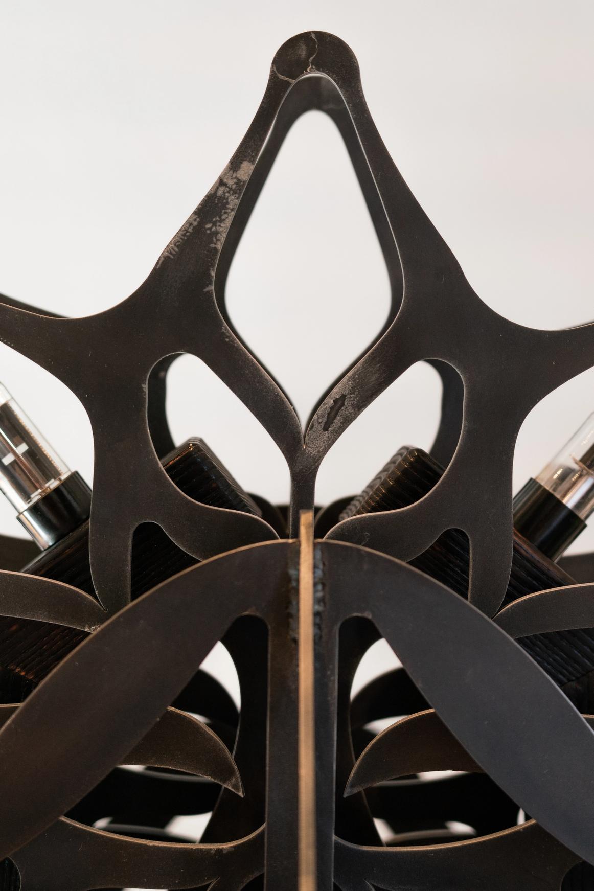 Ornamental blackened steel amplifier with tubes.