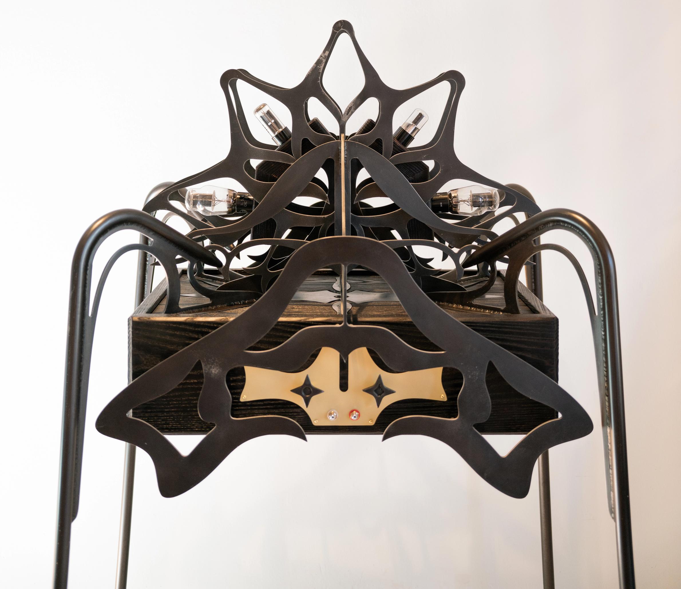 Ornamental blackened steel amplifier with tubes.