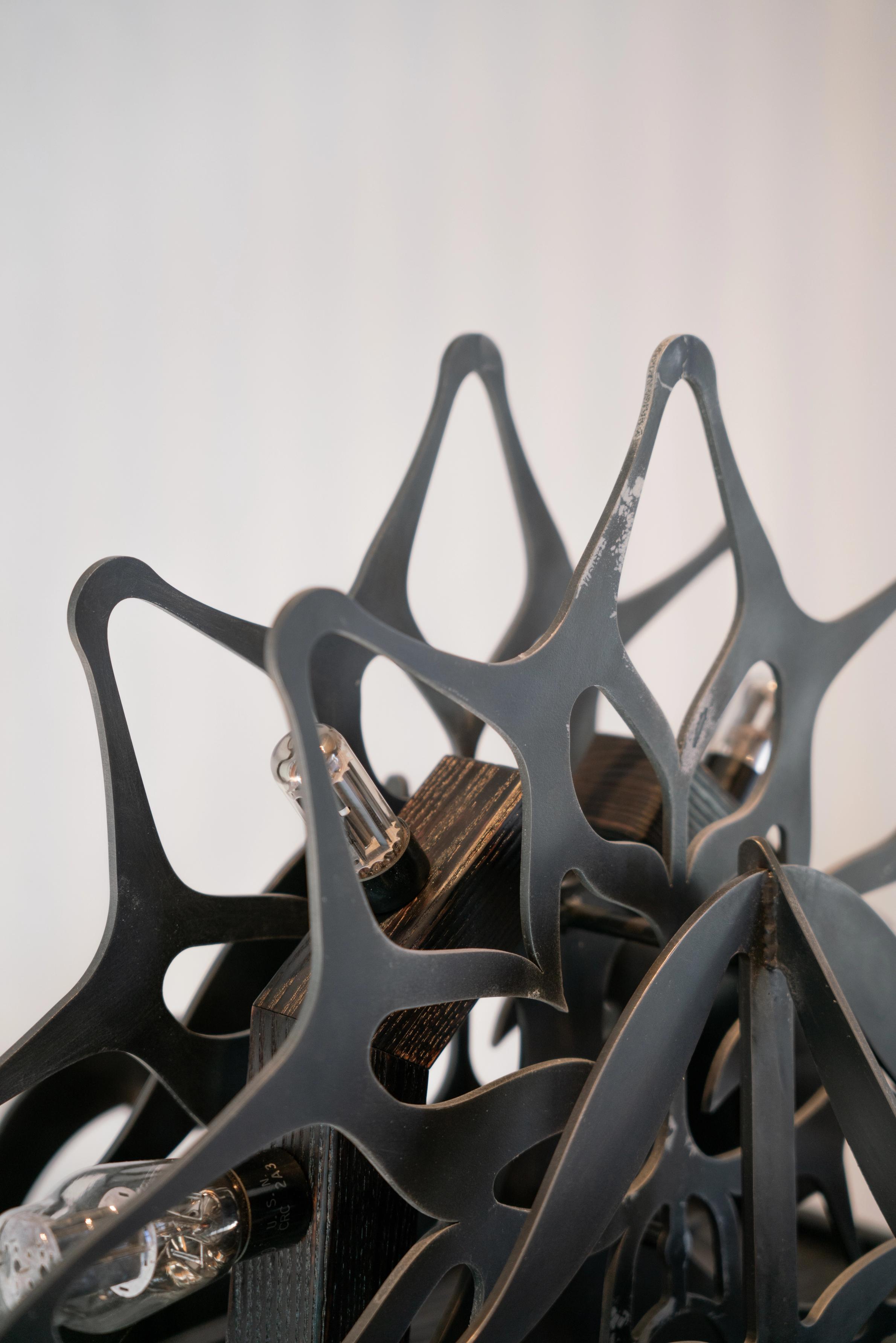Ornamental blackened steel amplifier with tubes.