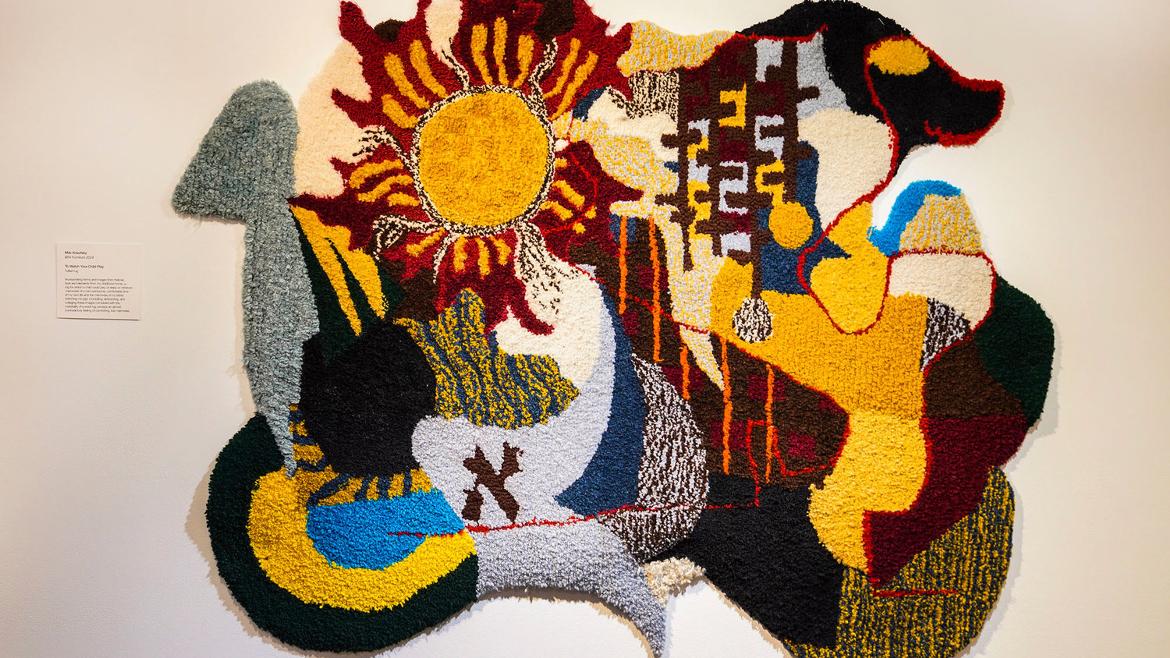 Colorful rug hung on the wall.