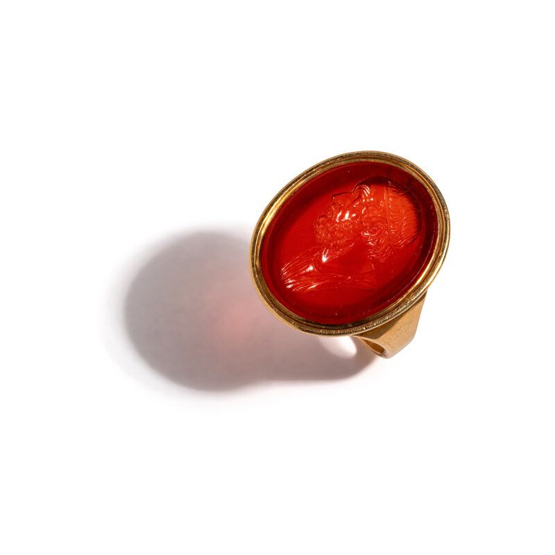 Lot 226 | A Neoclassical Gold and Carnelian Finger Ring with a Portrait Bust of Homer | Estimate: $2,000 - 3,000