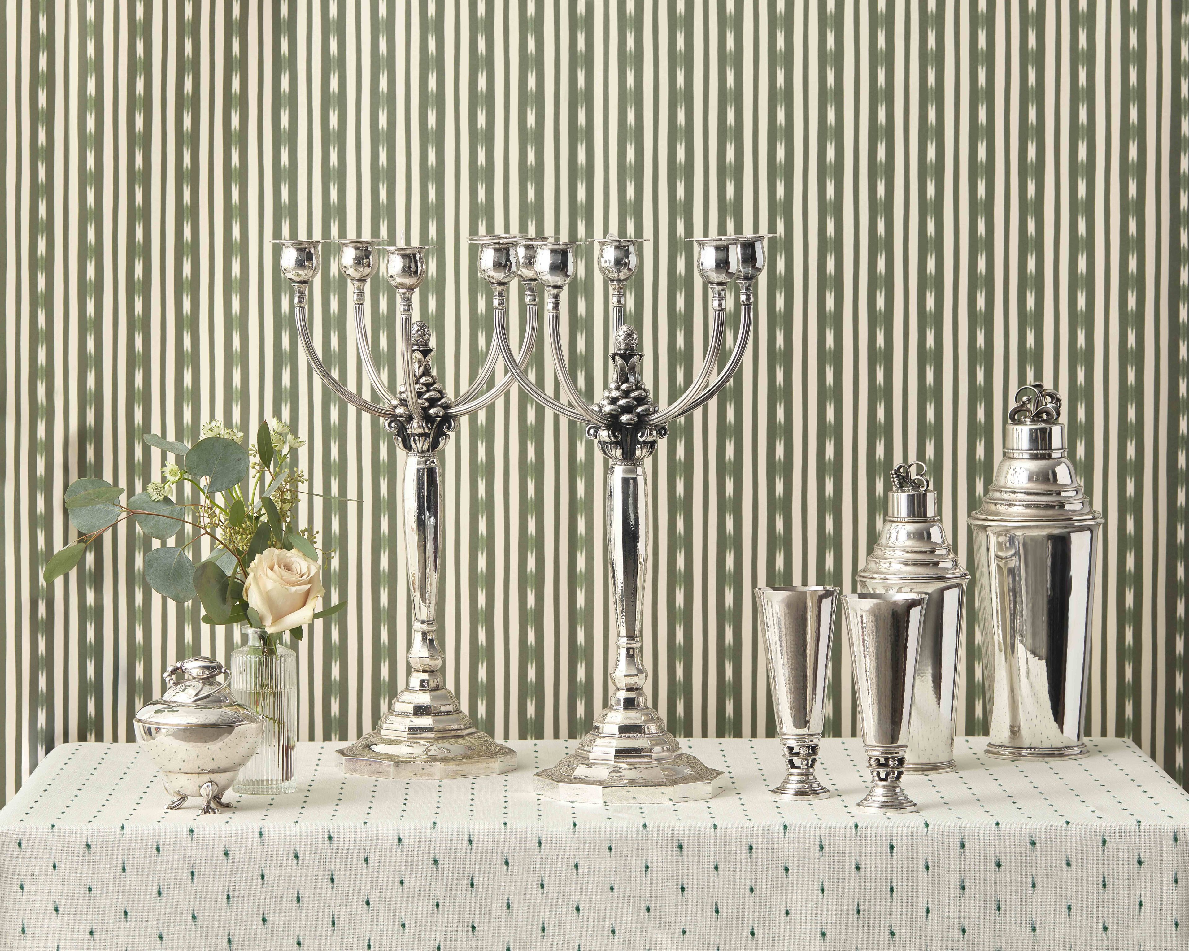 From left to right:
Lot 31 | A Pair of Johan Rohde Designed Georg Jensen Silver Acorn Pattern Five-Light Candelabra |
Estimate: $30,000 - 50,000
Lot 33 | A Pair of Johan Rohde Designed Georg Jensen Silver Vases | Estimate: $1,500 – 2,500
Lot 48 | A Harald Nielsen Designed Georg Jensen Silver Cocktail Shaker | Estimate: $2,000 - 3,000
Lot 47 | A Large Harald Nielsen Designed Georg Jensen Cocktail Shaker | Estimate: $5,000 – 7,000