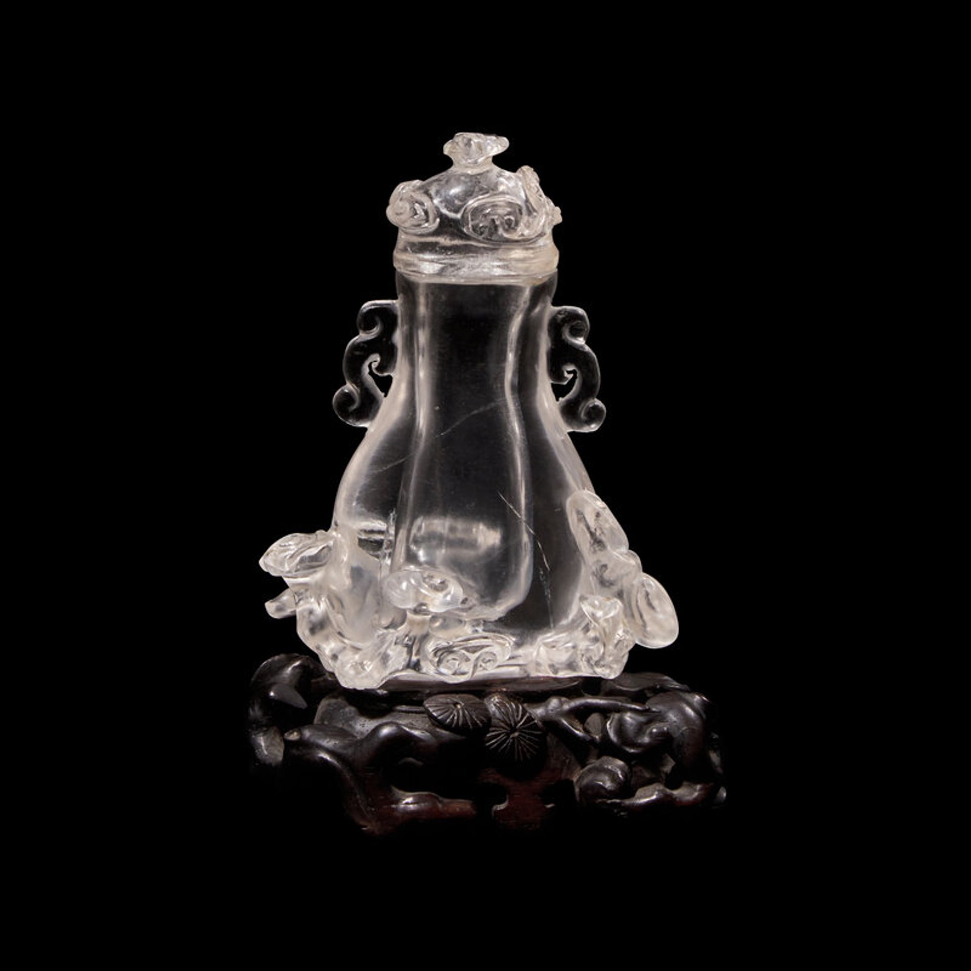Lot 161 | A Small Chinese Rock Crystal Vase and Cover with Wood Stand, Qing Dynasty, 清 水晶靈芝紋小蓋瓶, Estimate: $1,000 - $2,000