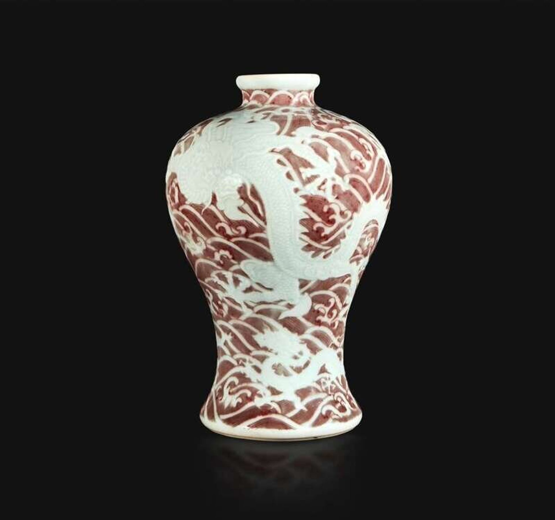 A Chinese carved and underglaze red "Dragons and Waves" vase, Meiping Yongzheng six-character mark and of the period