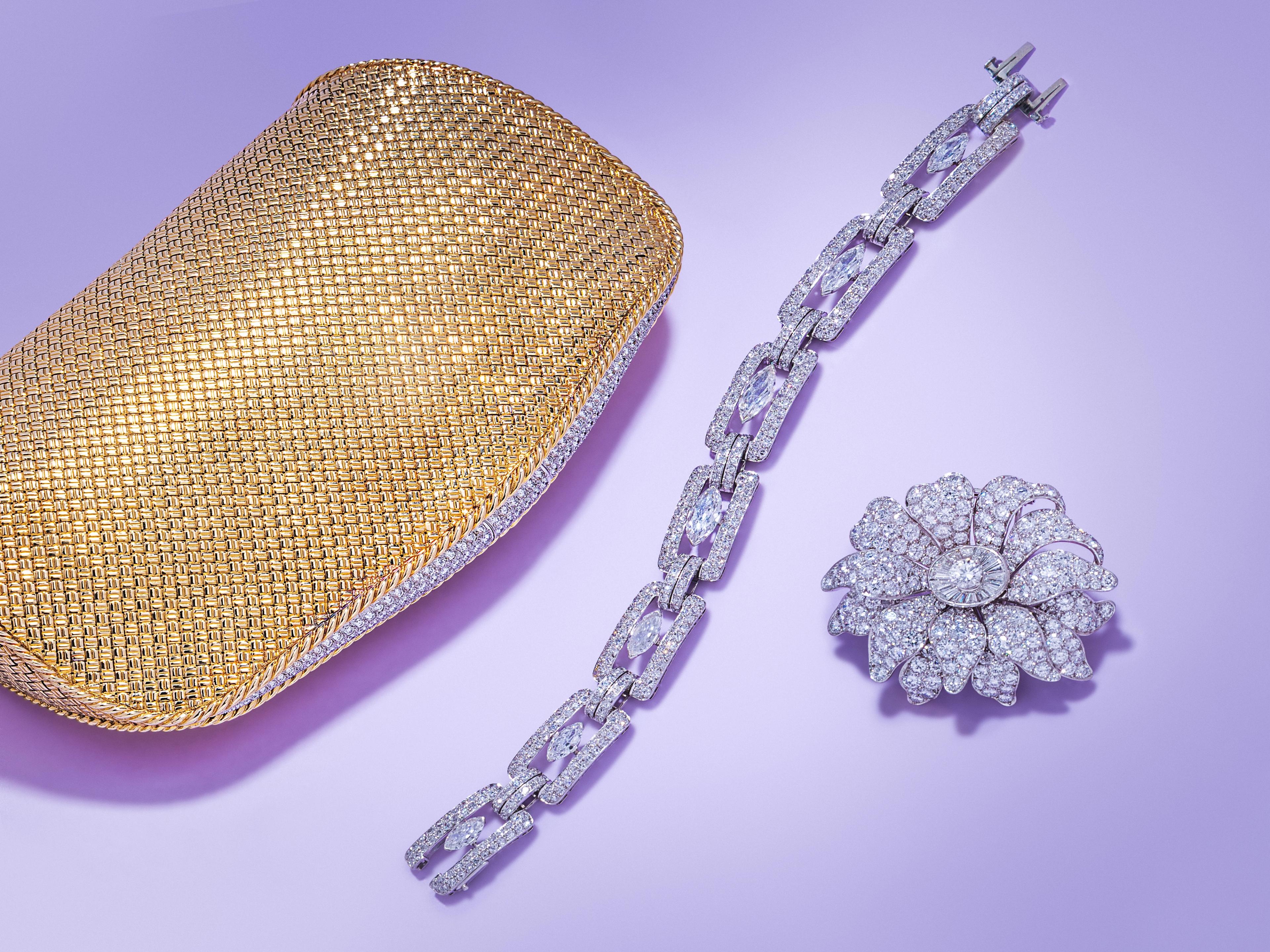 From left to right: Lot 91 | VAN CLEEF & ARPELS, YELLOW GOLD AND DIAMOND CLUTCH |
Estimate: $40,000 - 60,000
Lot 105 | CHARLTON & CO., ART DECO, DIAMOND AND PLATINUM BRACELET | Estimate: $18,000 - 22,000
Lot 101 | VAN CLEEF & ARPELS, DIAMOND AND PLATINUM FLOWER BROOCH | Estimate: $50,000 - 70,000