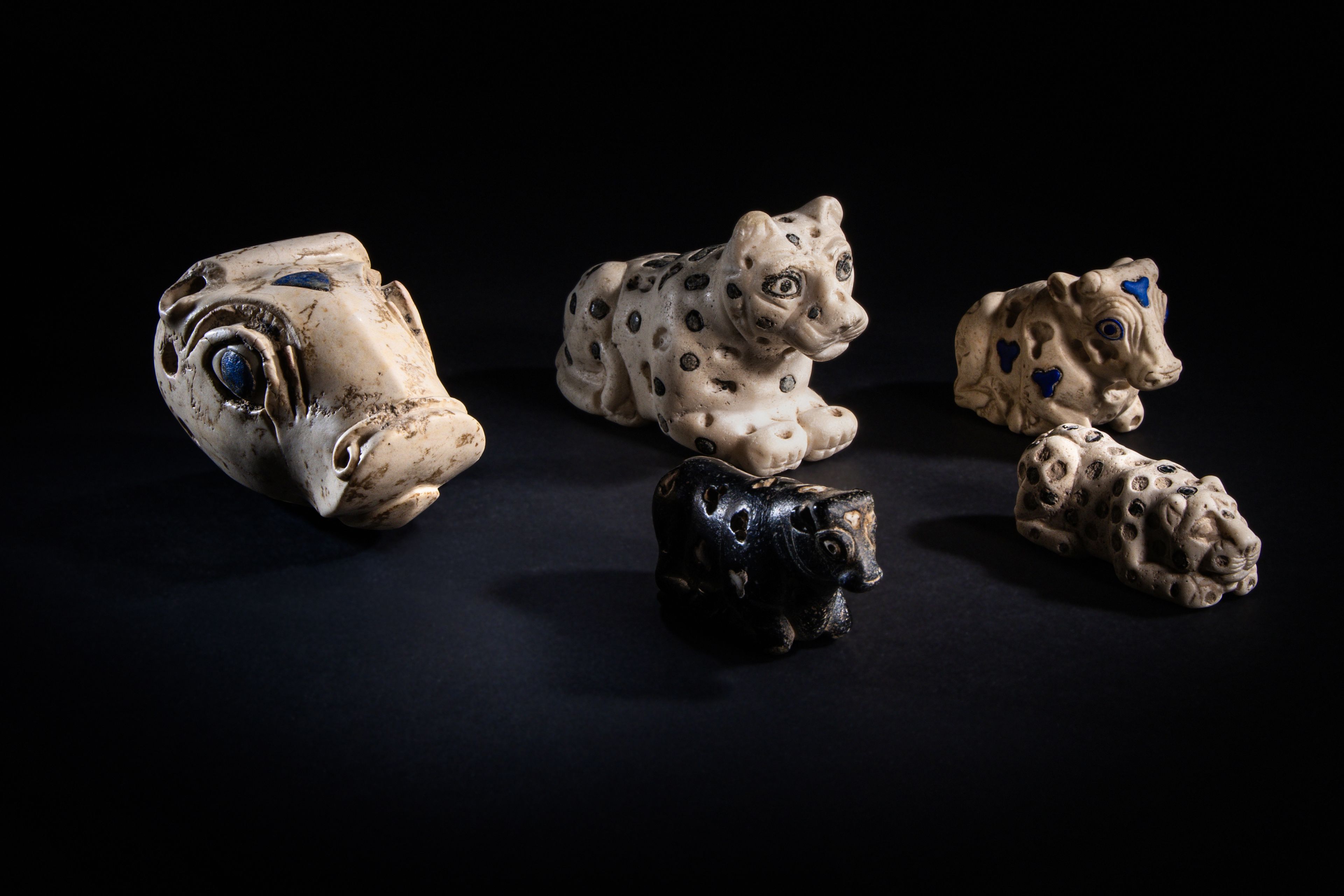 Mesopotamian statuettes of recumbent cows and felines including a Limestone and Lapis Lazuli Inlay Recumbent Calf (far right), Late Uruk-Jemdat Nasr Period, Circa 3300-2900 B.C., Estimate: $5,000 – 7,000