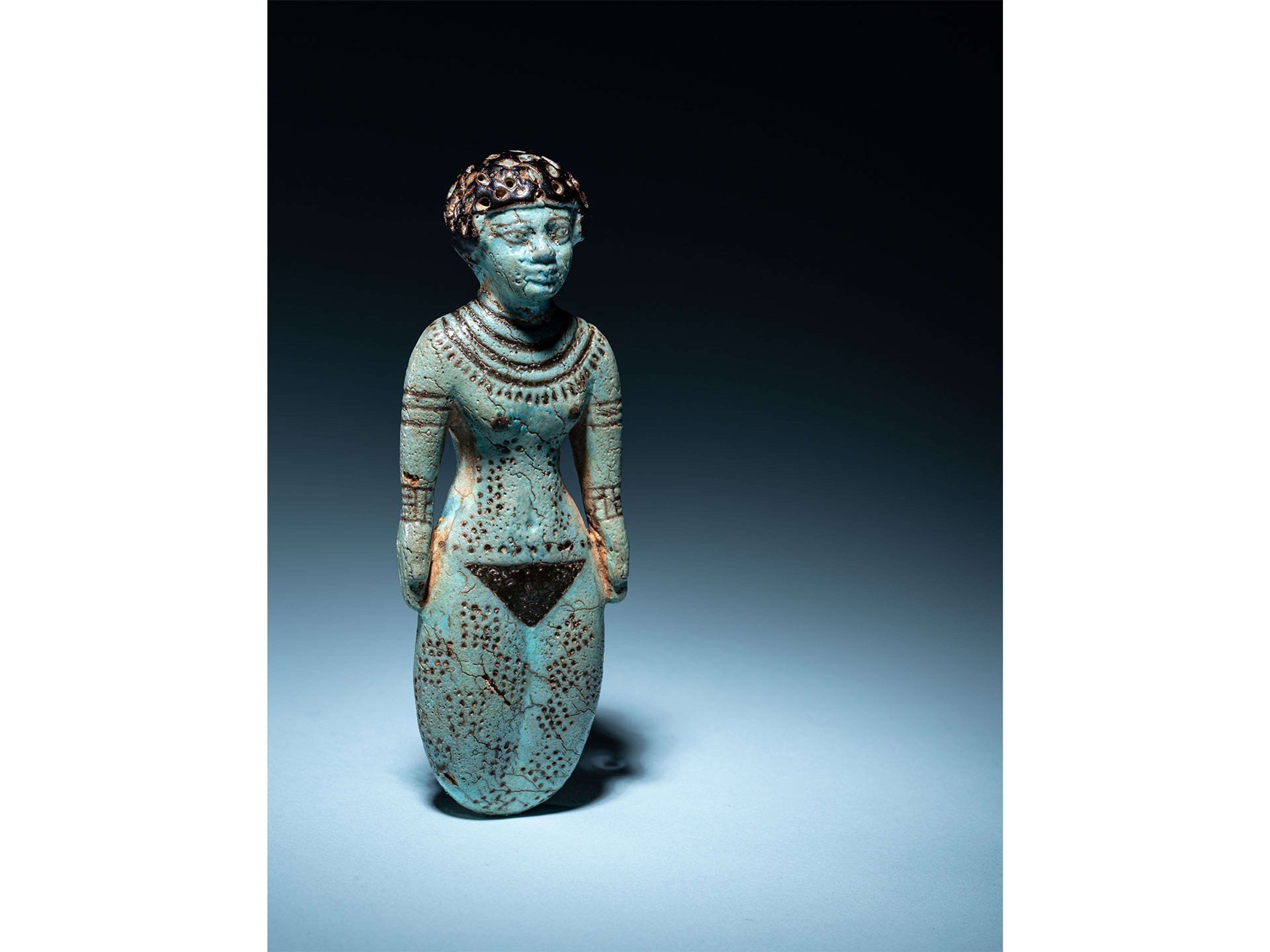 An Egyptian Faience Female Figure  Middle Kingdom, 12th Dynasty, 1991-1783 B.C.