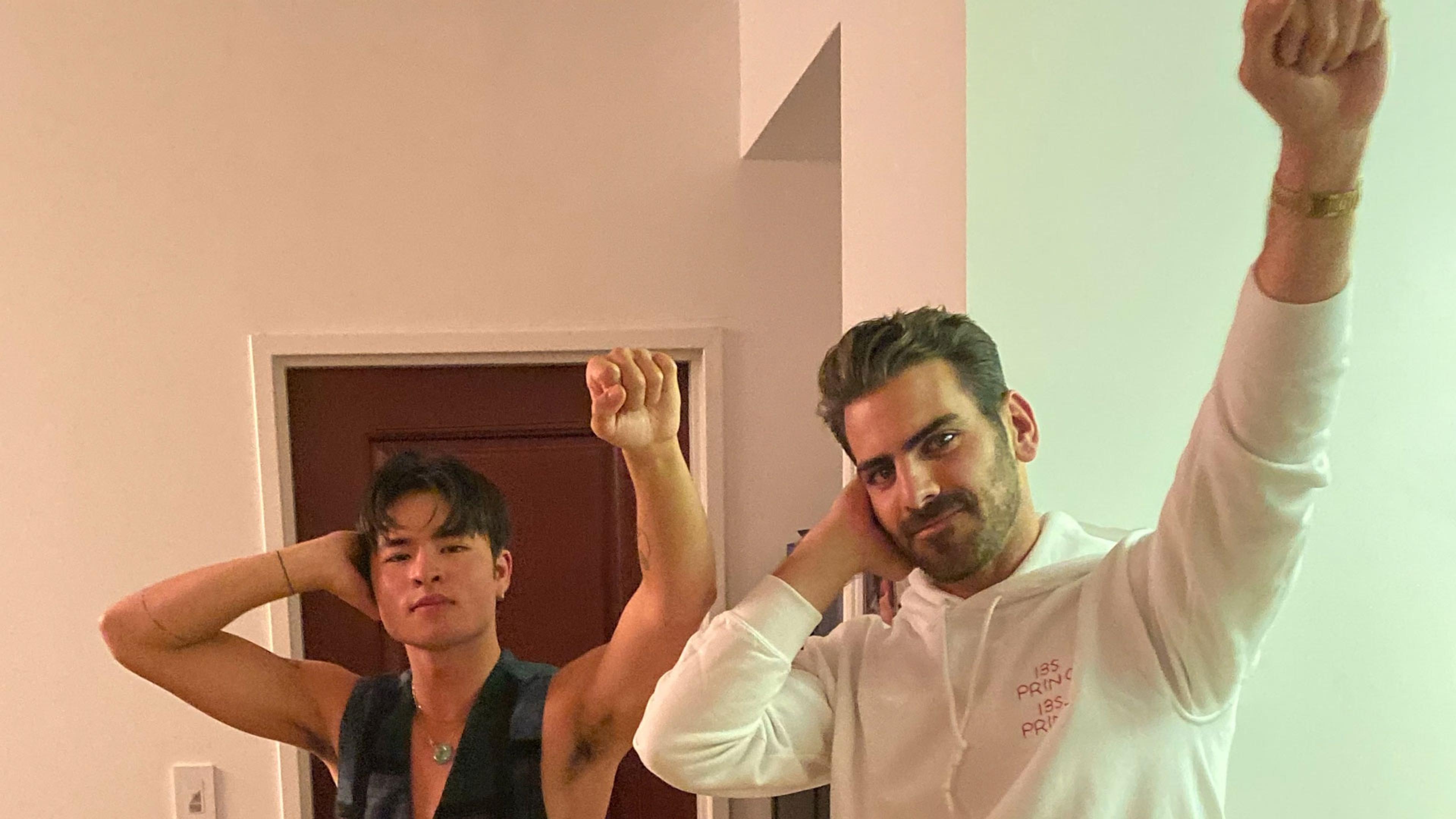 Two men in a doorway making the Deaf Power sign