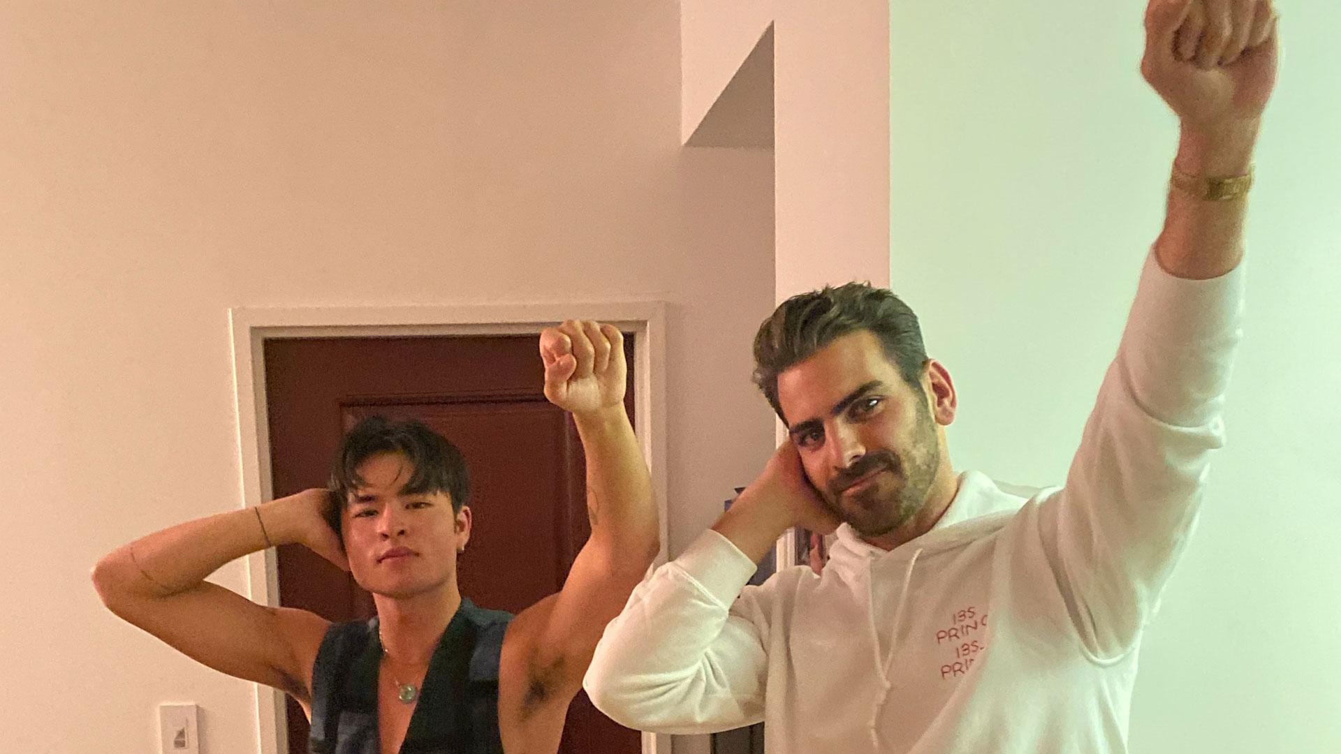 Two men in a doorway making the Deaf Power sign