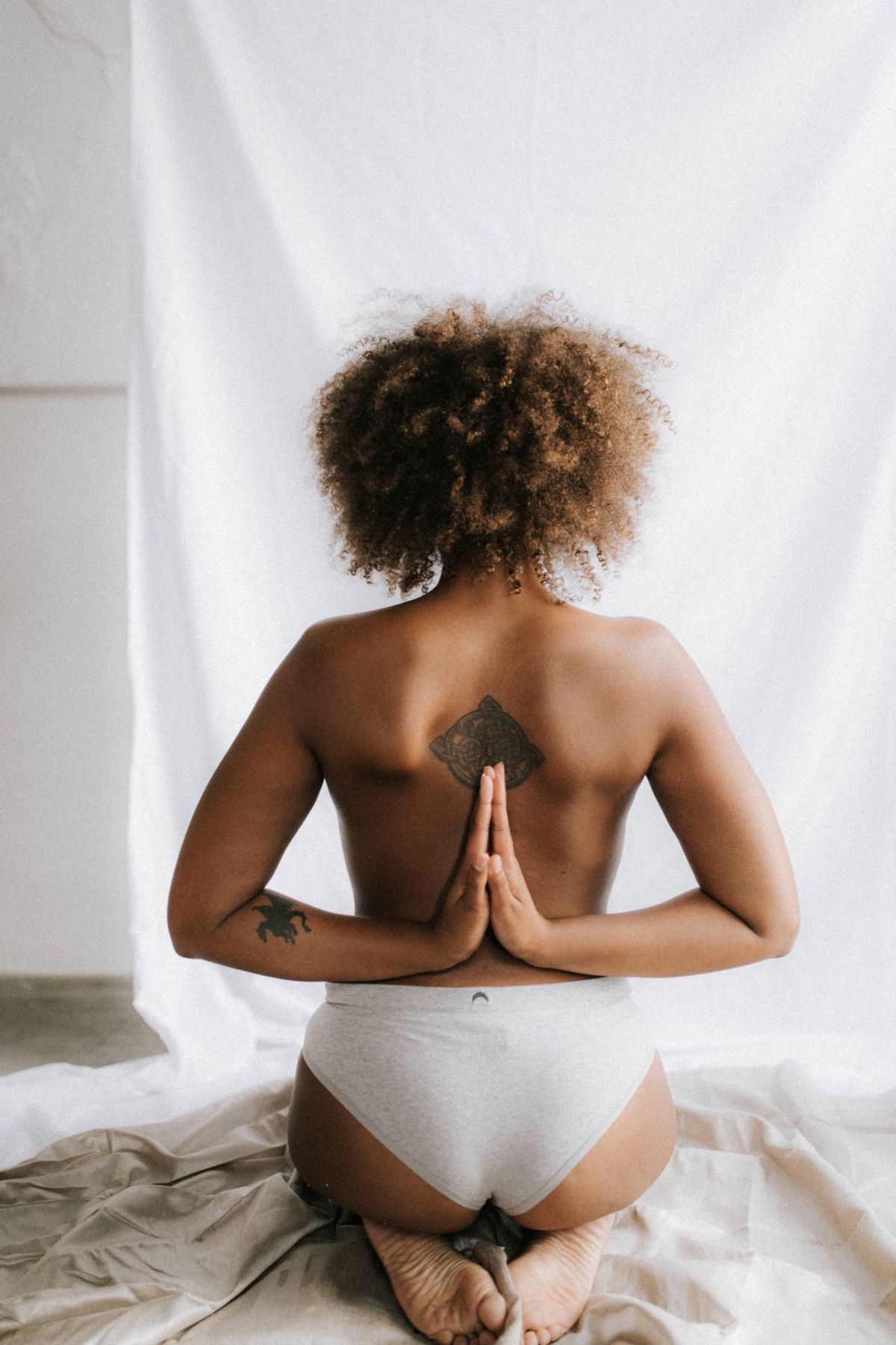 Woman with hands joined behind her back