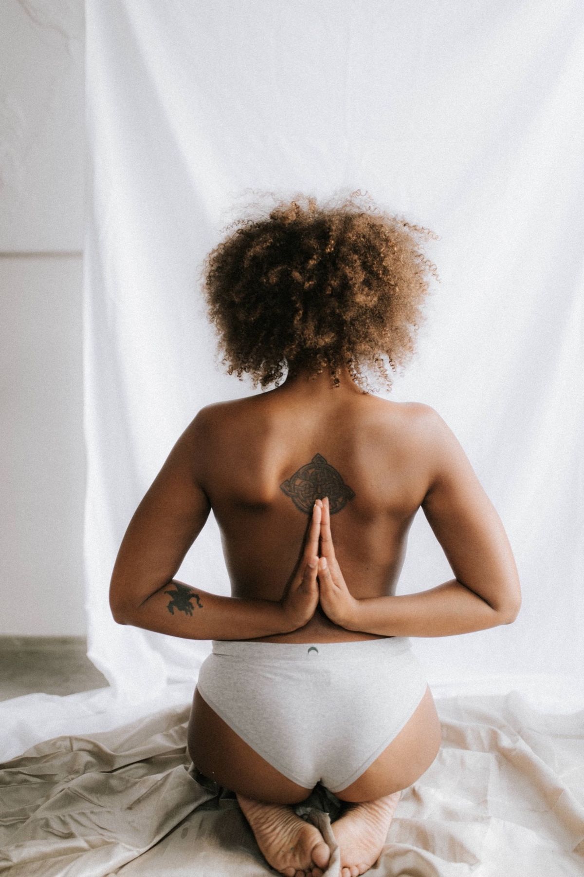 Woman with hands joined behind her back