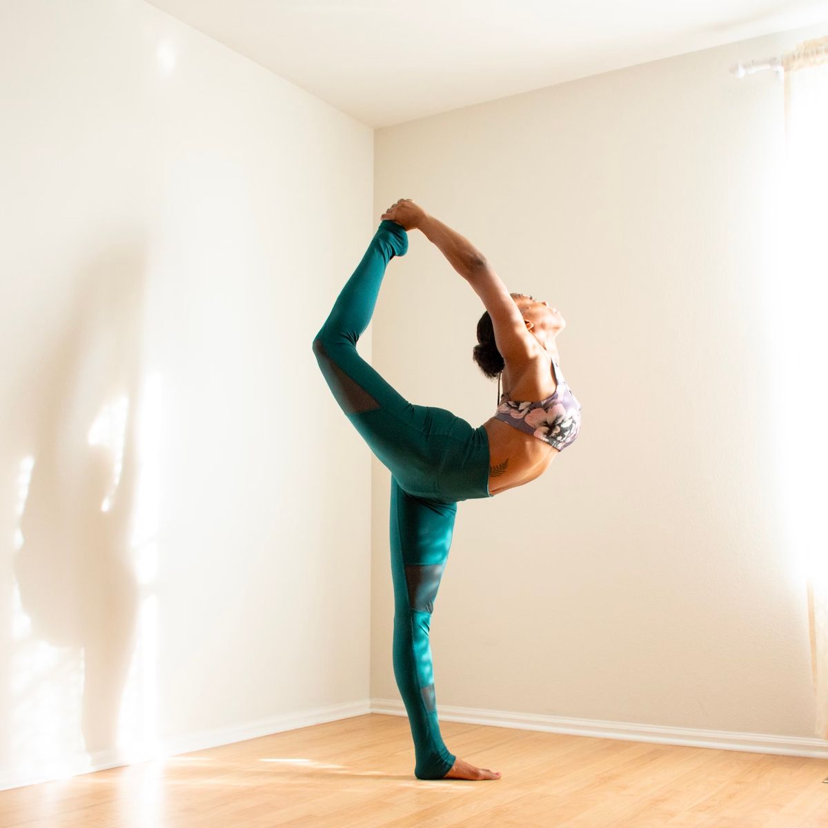 Yoga teacher in a standing bow pose