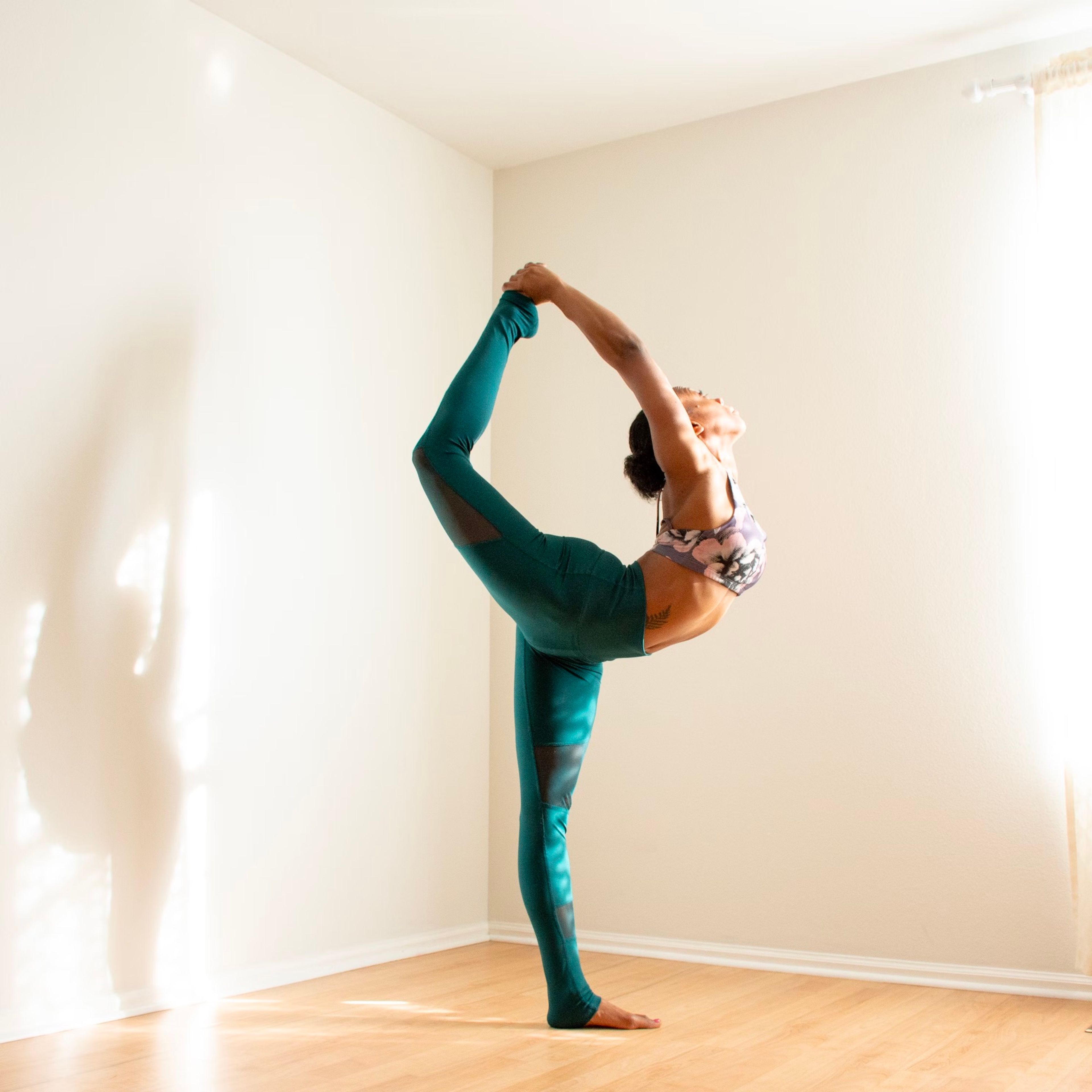 Yoga teacher in a standing bow pose