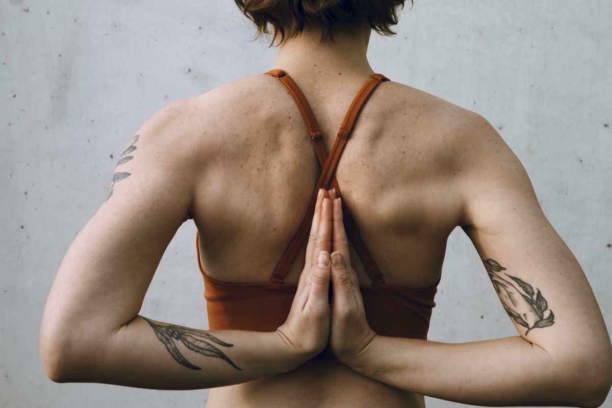 Back view of a woman with hands joined behind her back