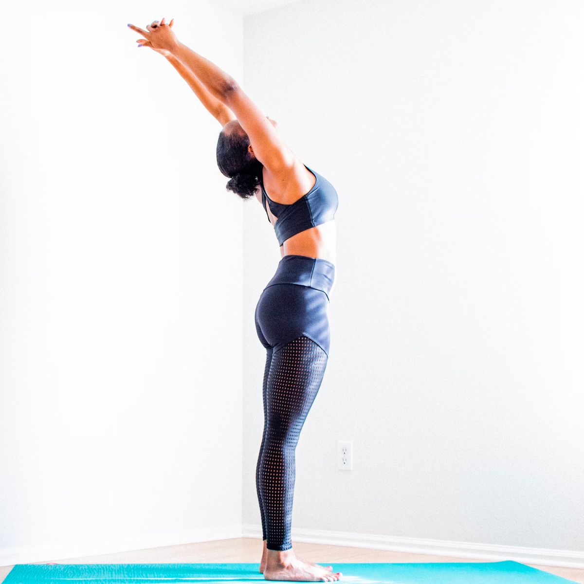 Yoga teacher reaching back in a standing backbend