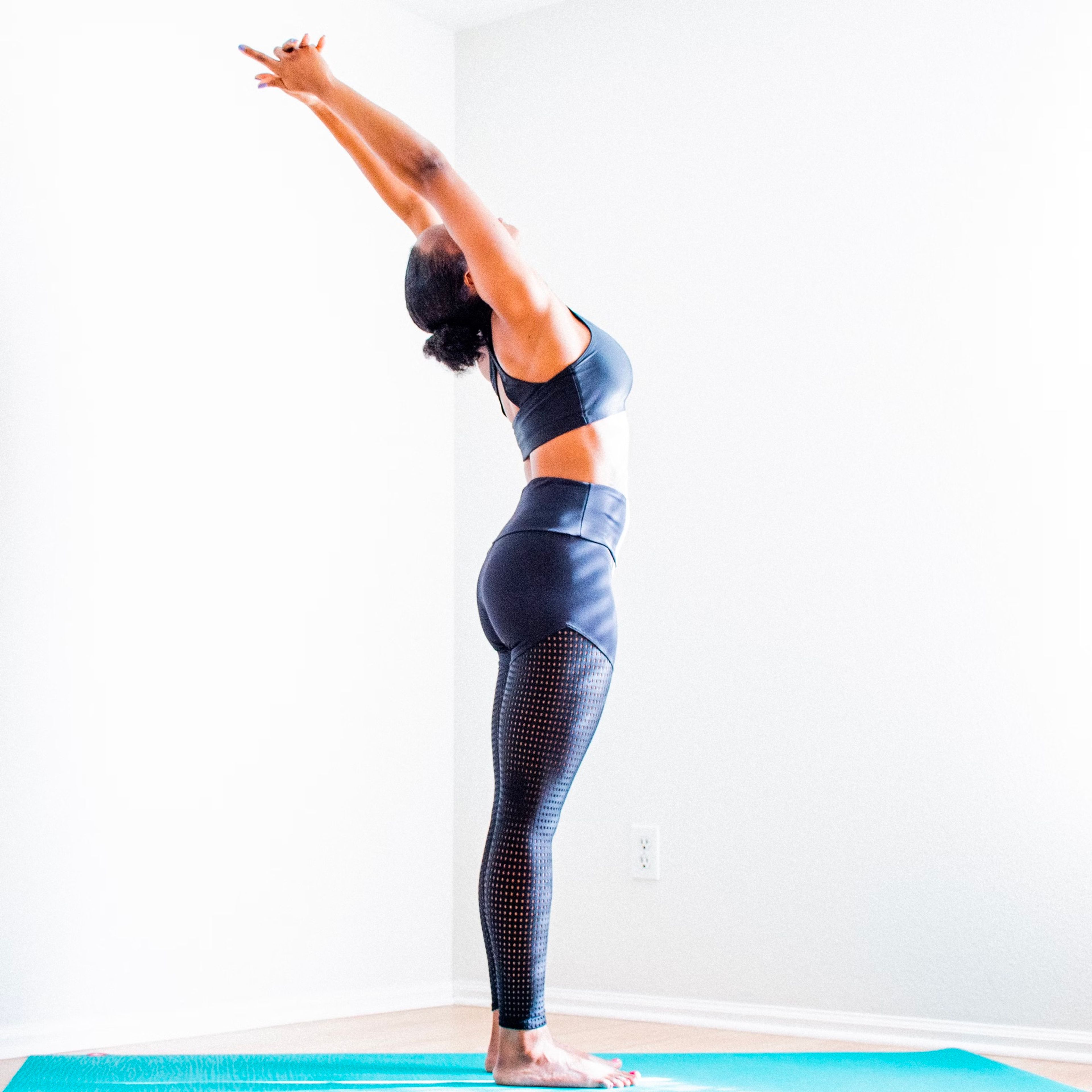 Yoga teacher reaching back in a standing backbend