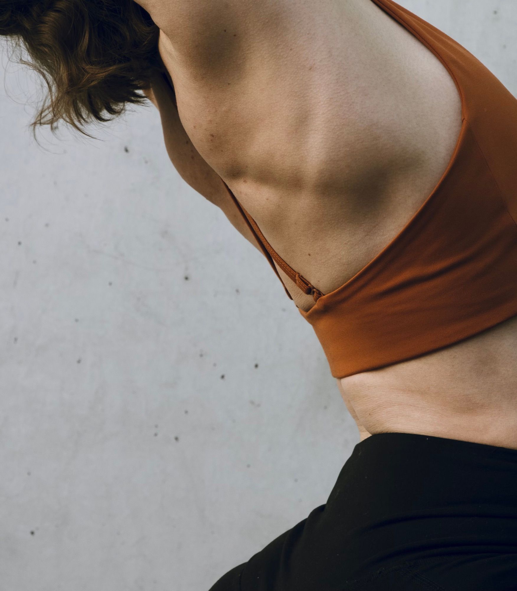 Teacher guiding a beginner into a pose