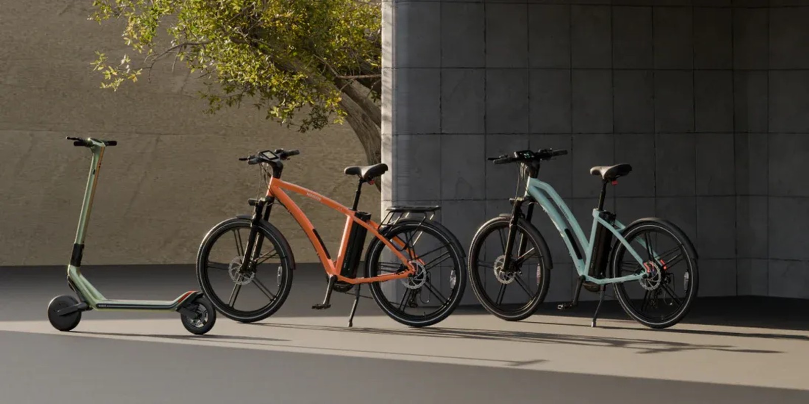NINE09 electric scooter and two eBikes parked together as urban alternatives to the car