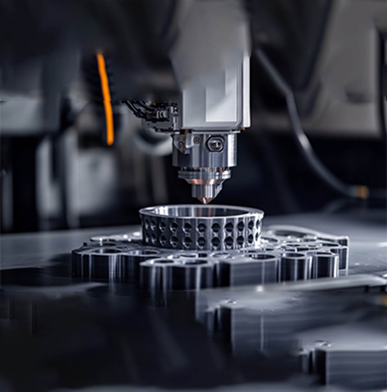 Metal 3D Printing Process Photo of a metal 3D printer laser sintering a gear-shaped component
